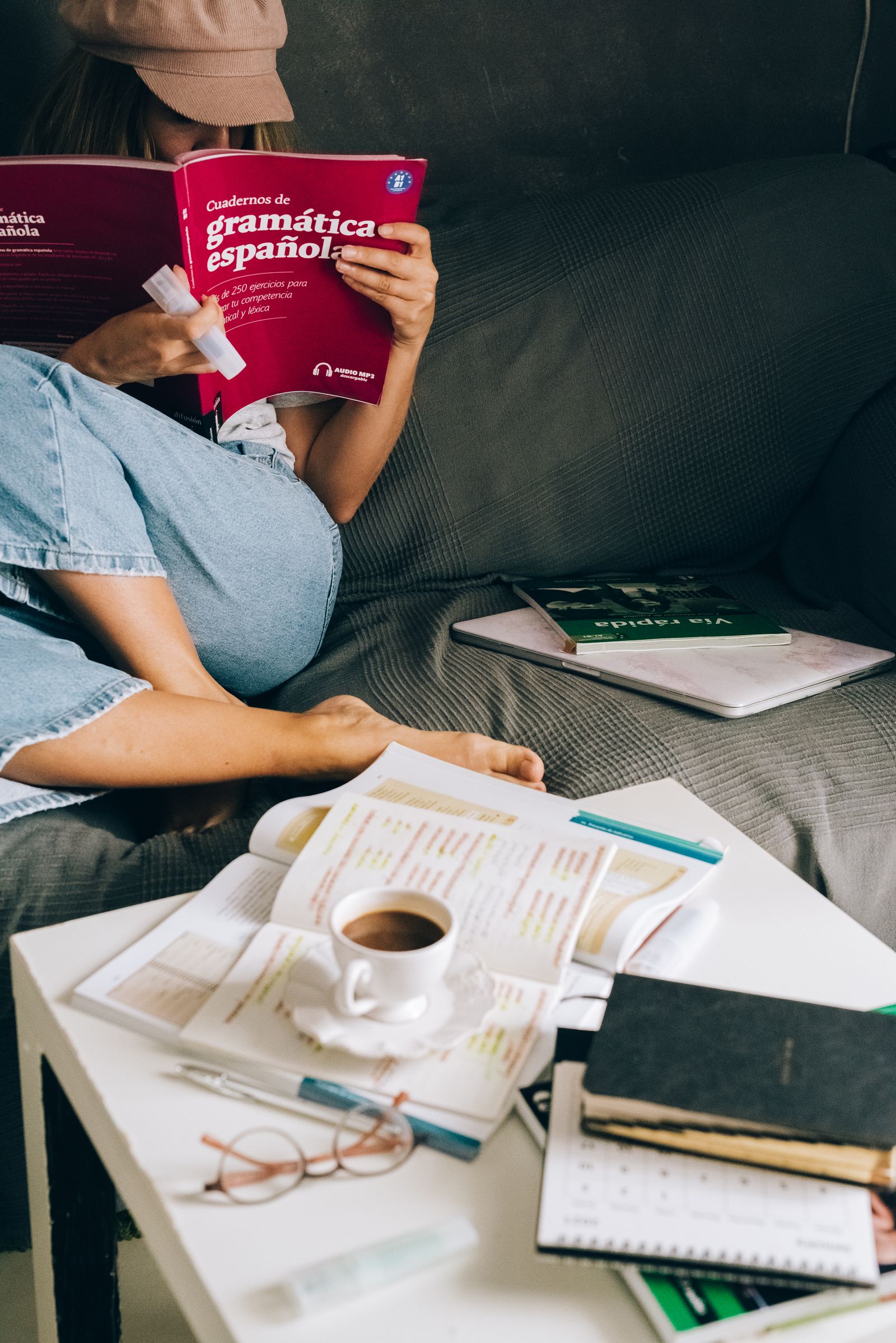 Woman reading a book on a couch