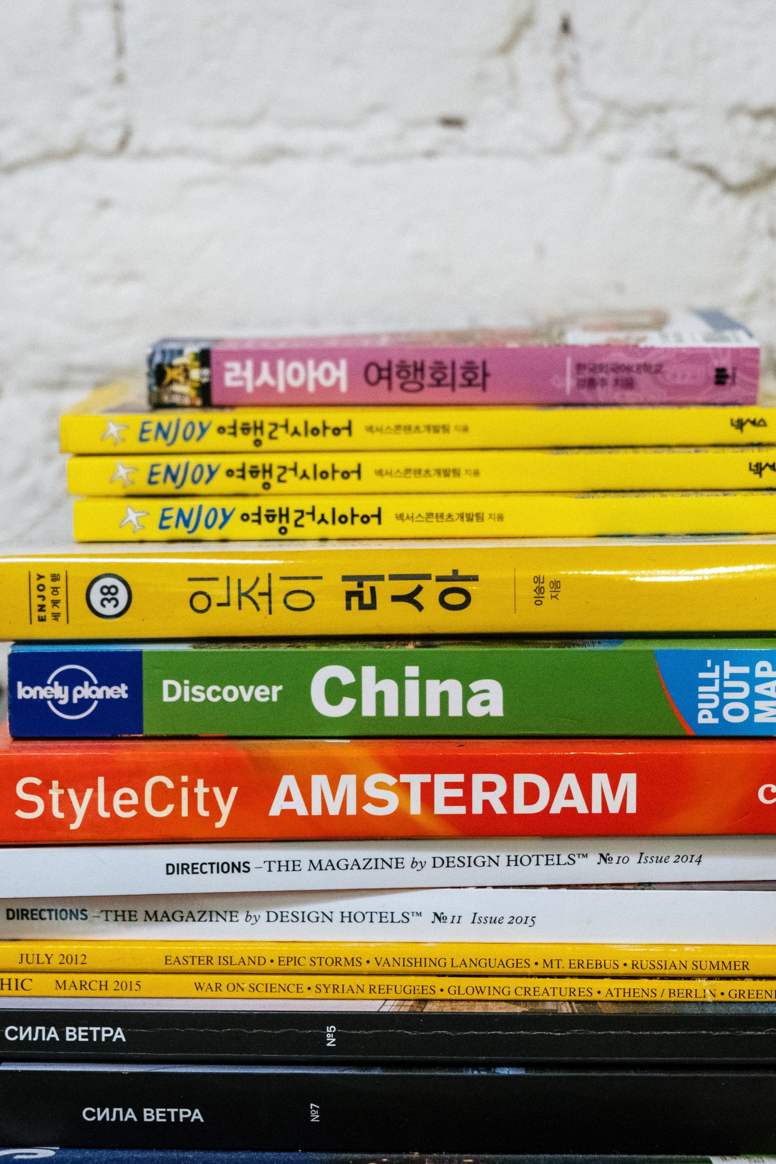 Stack of books against a brick wall