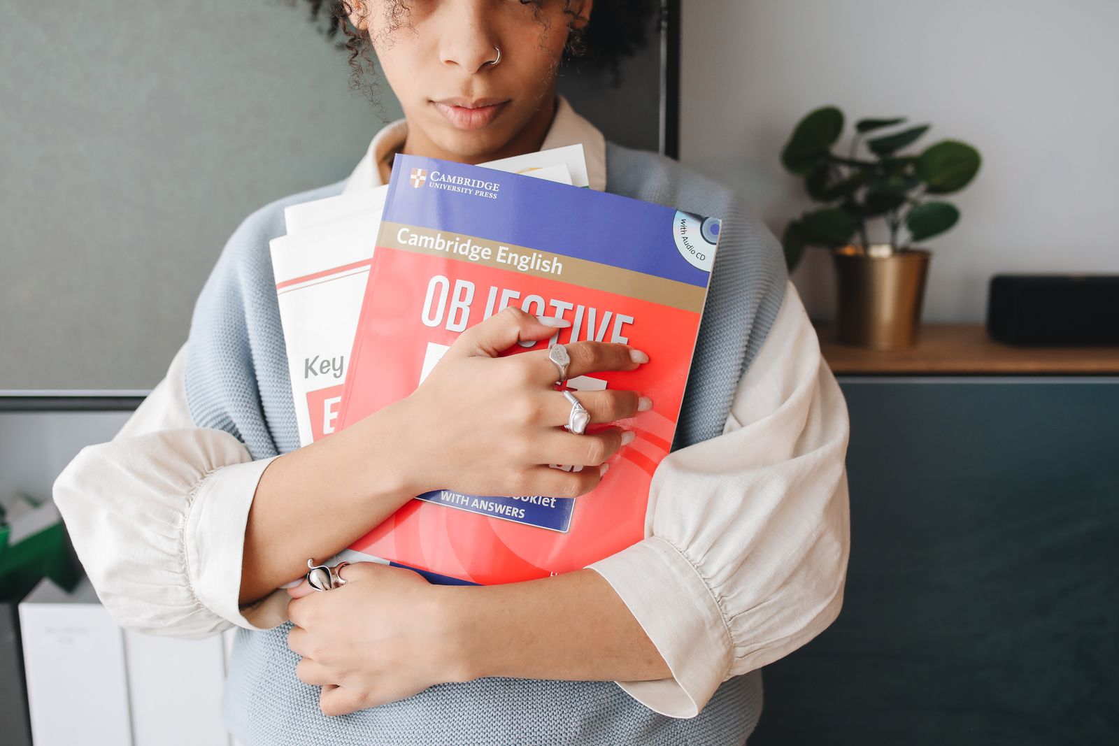 Woman standing while holding books