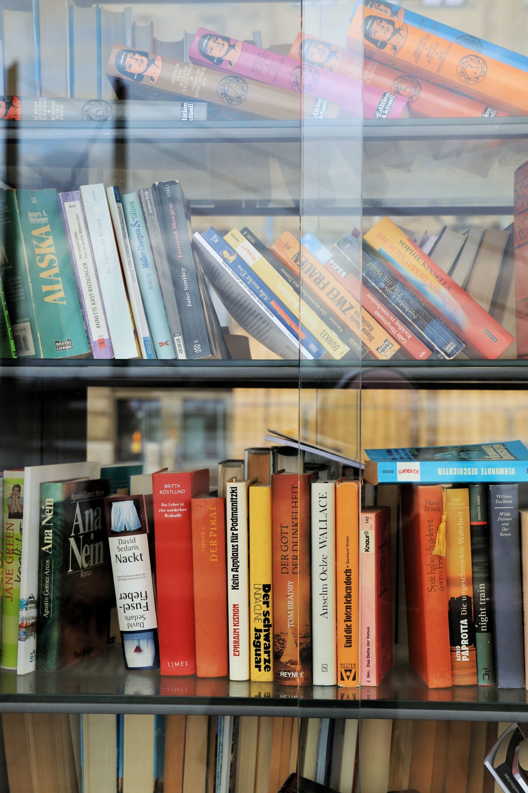 Rows of books lined up on library bookshelves