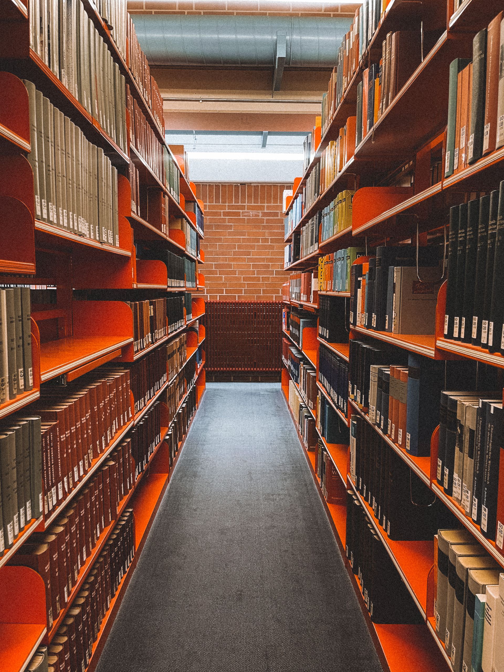 Symmetrical view of bookshelves in a library aisle