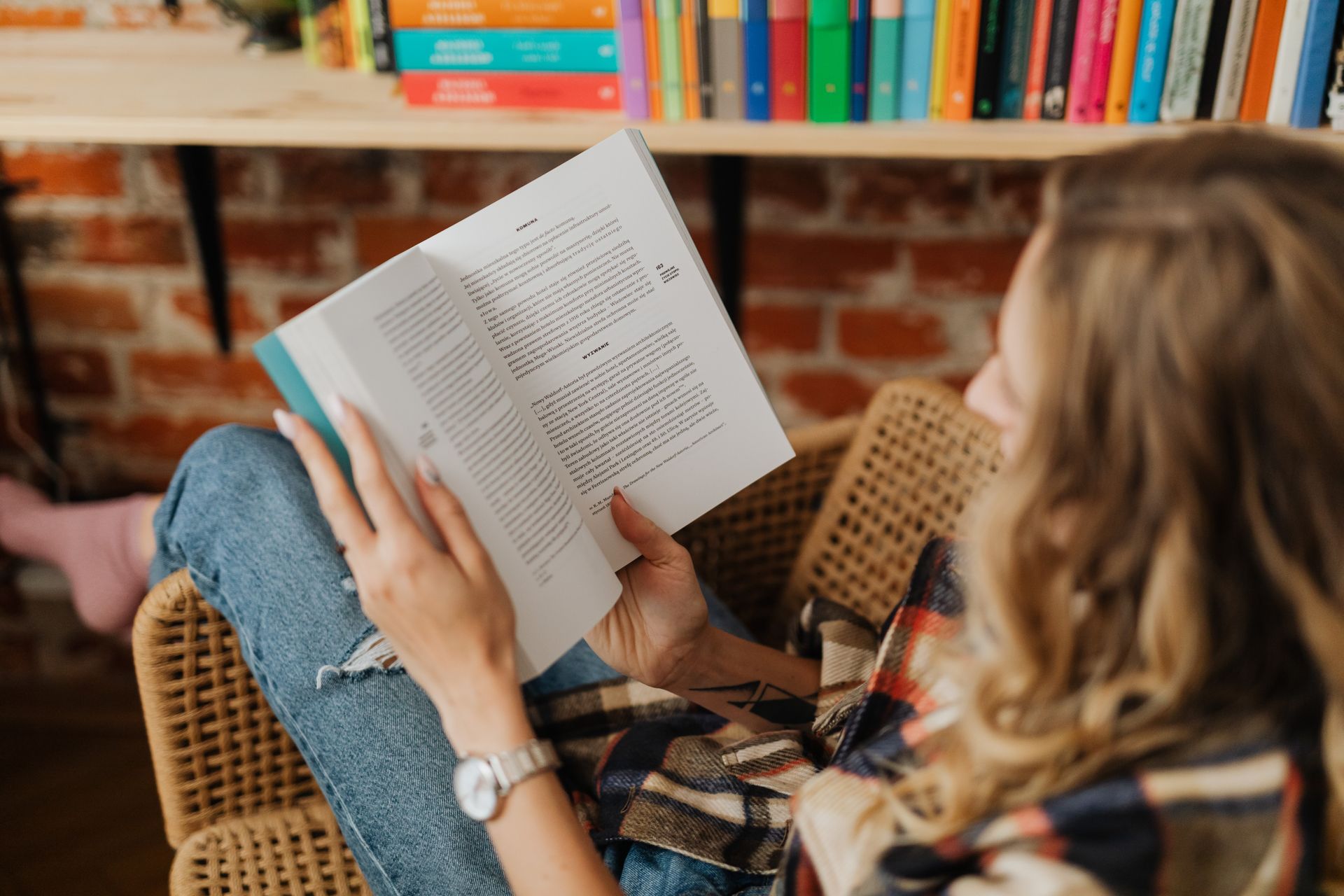 Woman reading a book in a cozy indoor setting