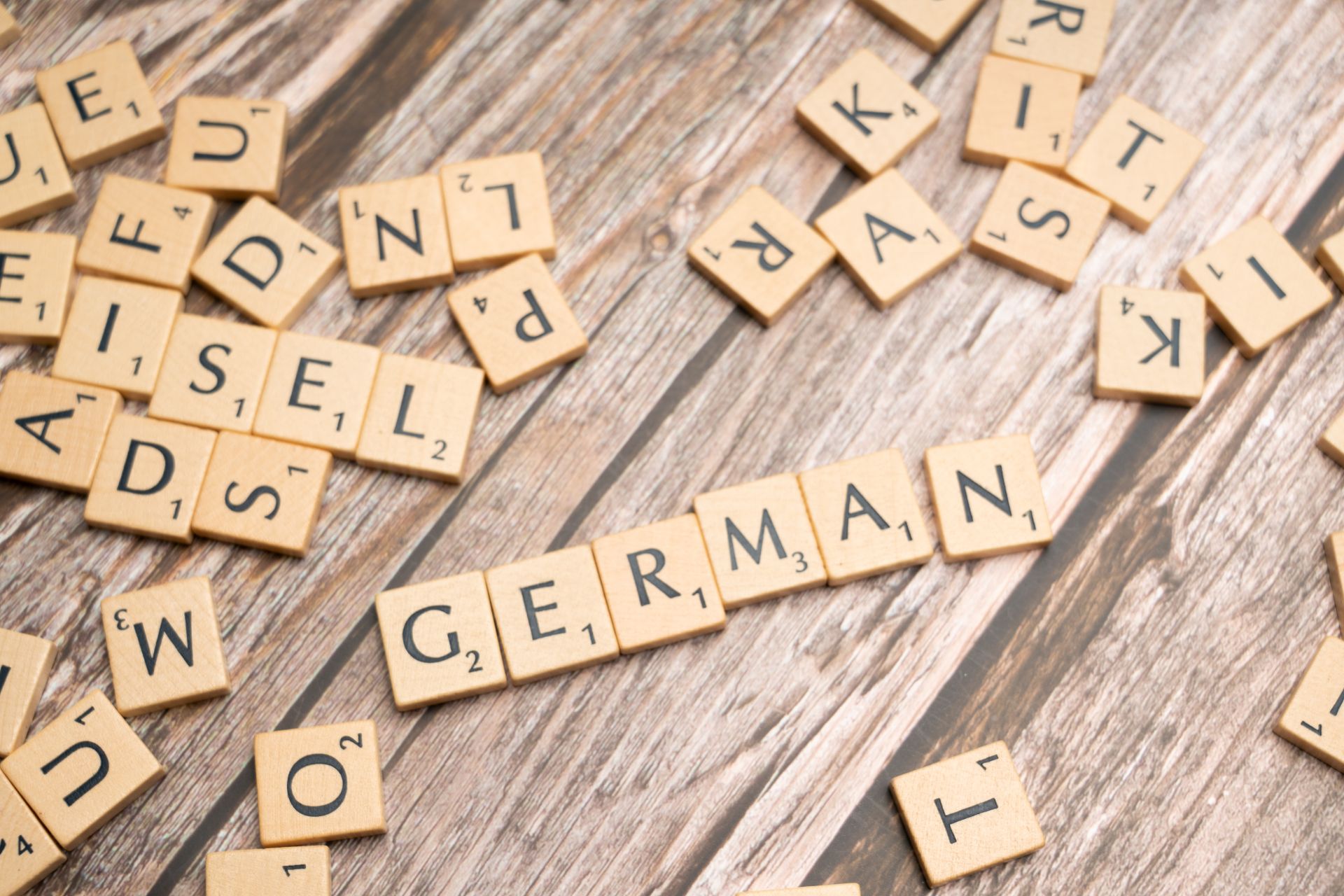 Wooden letter tiles spelling the word German on a table