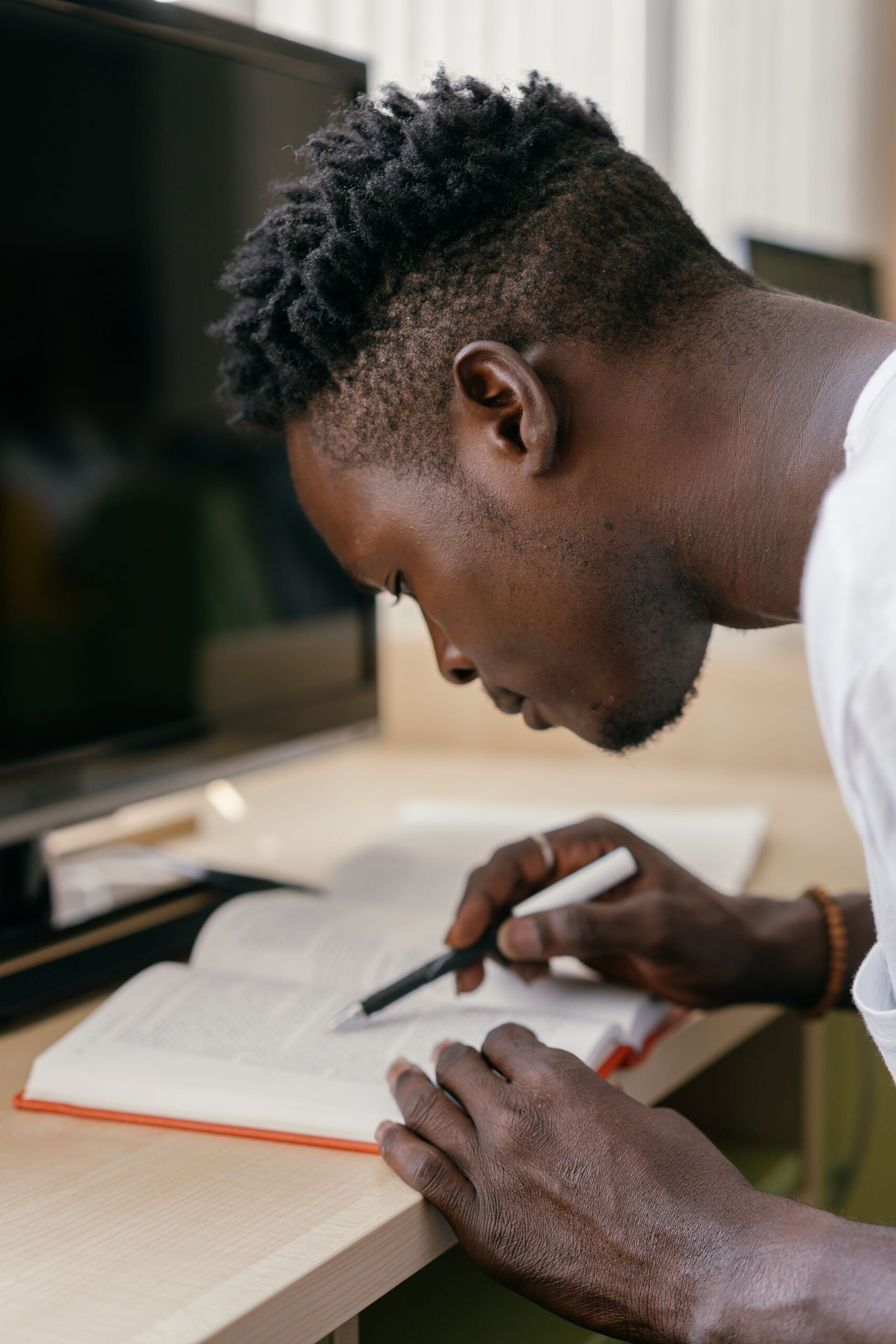Young man reading a book indoors