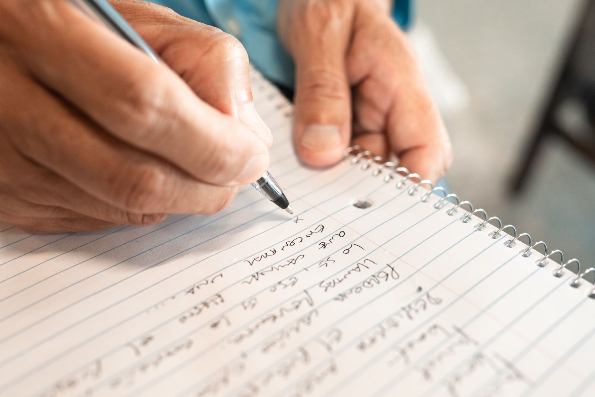 Hands writing in a notebook