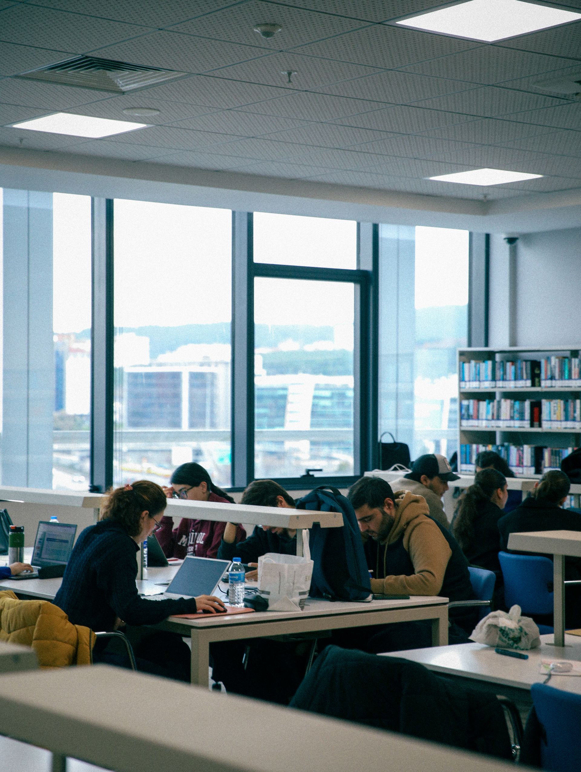 Students focused on studying in a bright modern library