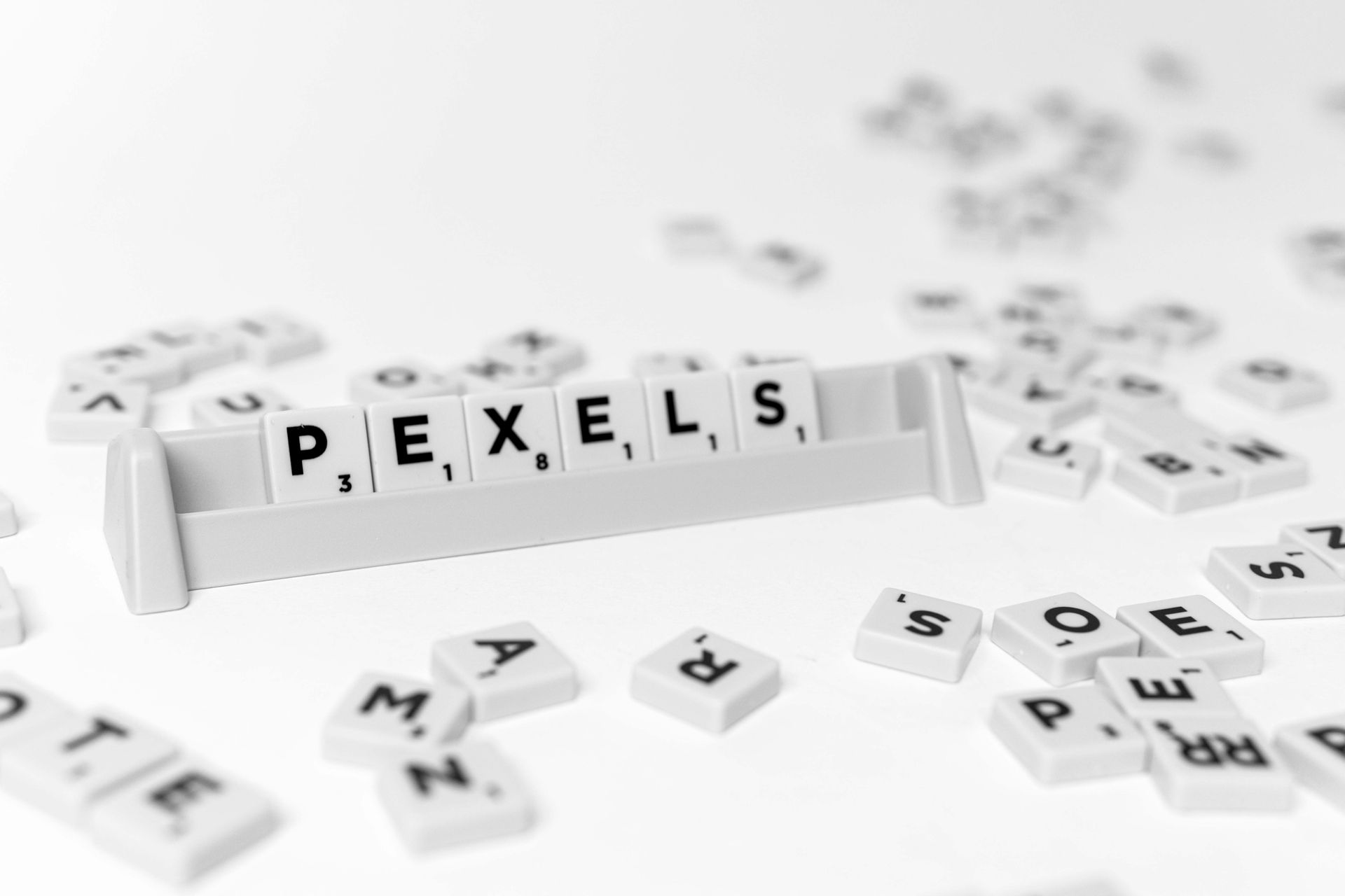 Assorted colorful letter tiles on a white background