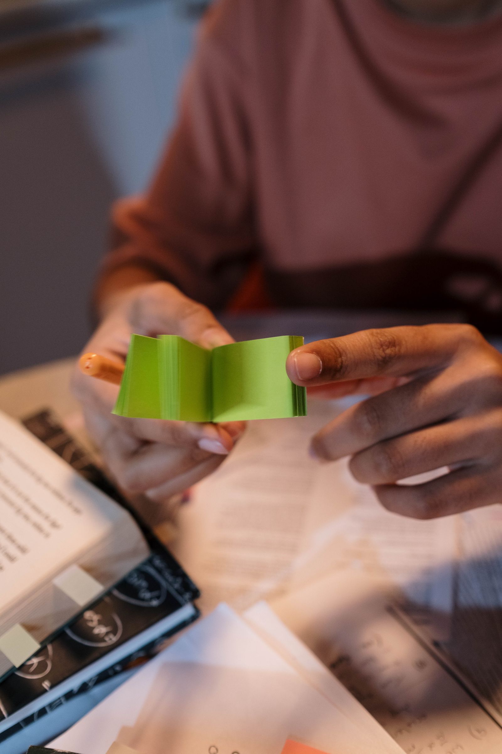 Hands holding green sticky notes