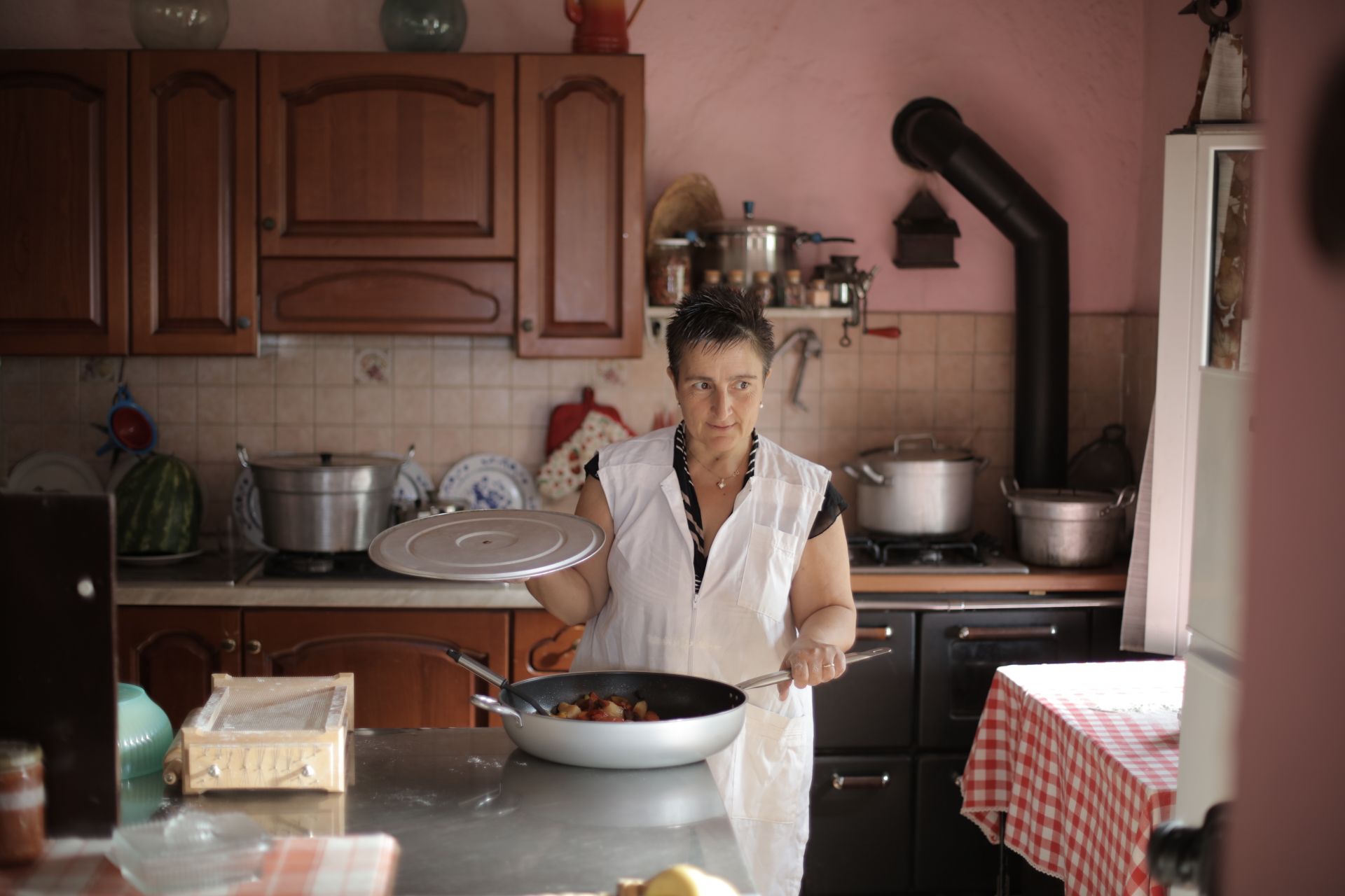 Woman cooking at home in a rustic kitchen