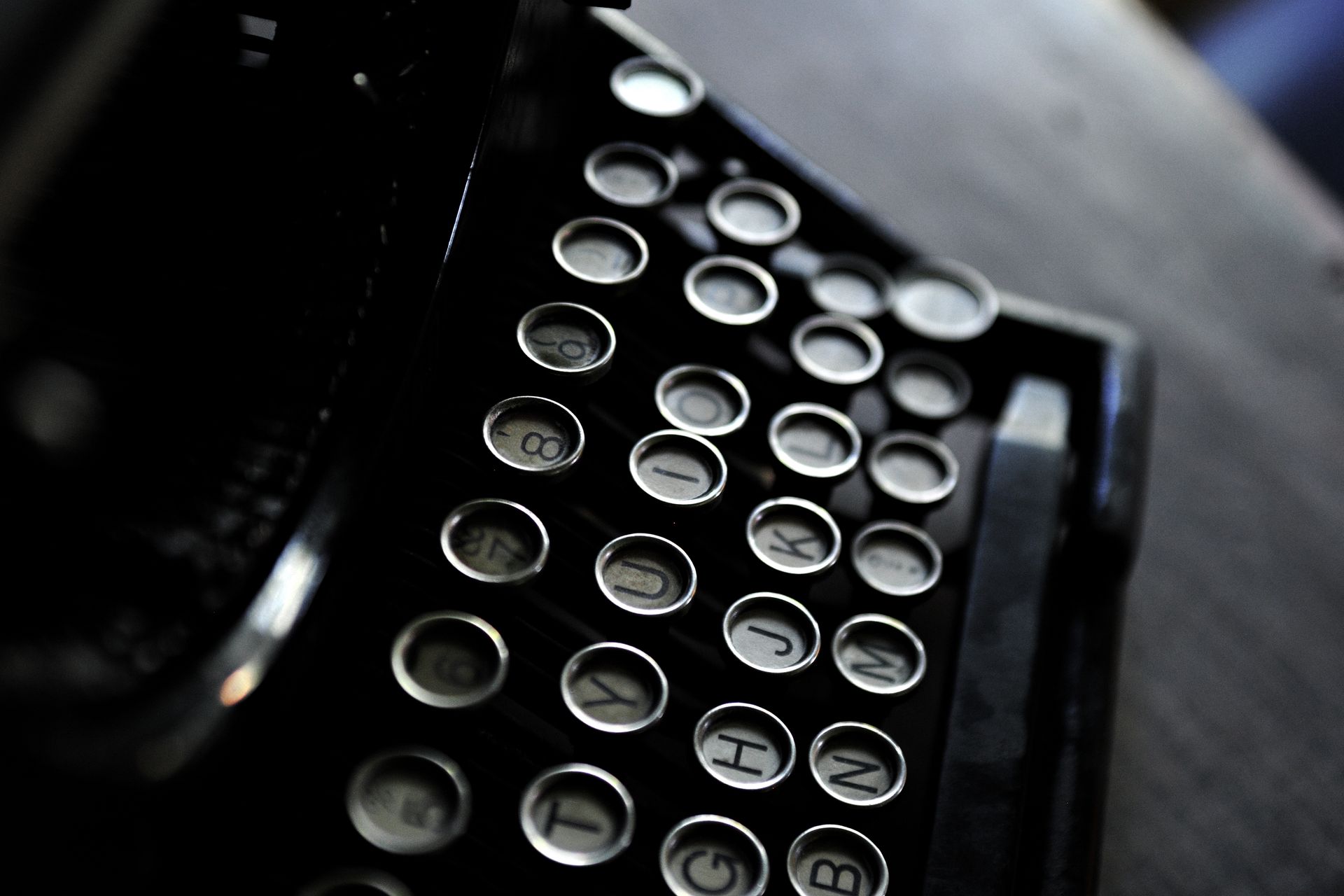 Artistic shot of vintage typewriter keys with a classic black and white contrast.