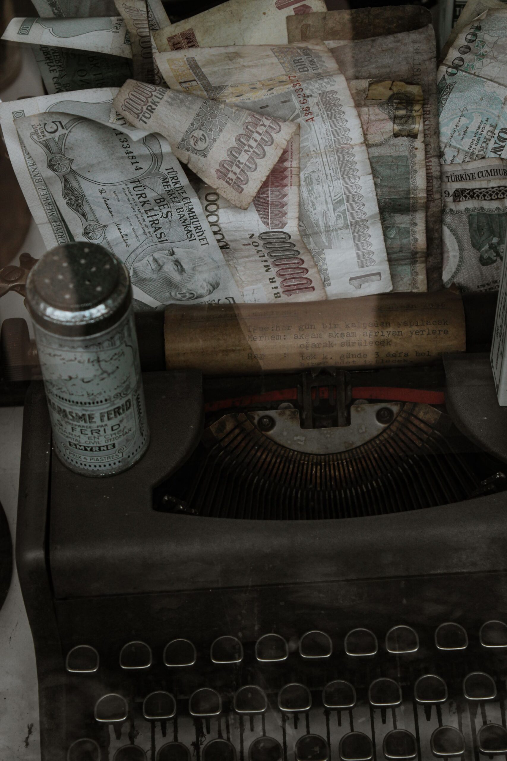 Close-up of a vintage typewriter with old banknotes, capturing a nostalgic and retro feel.