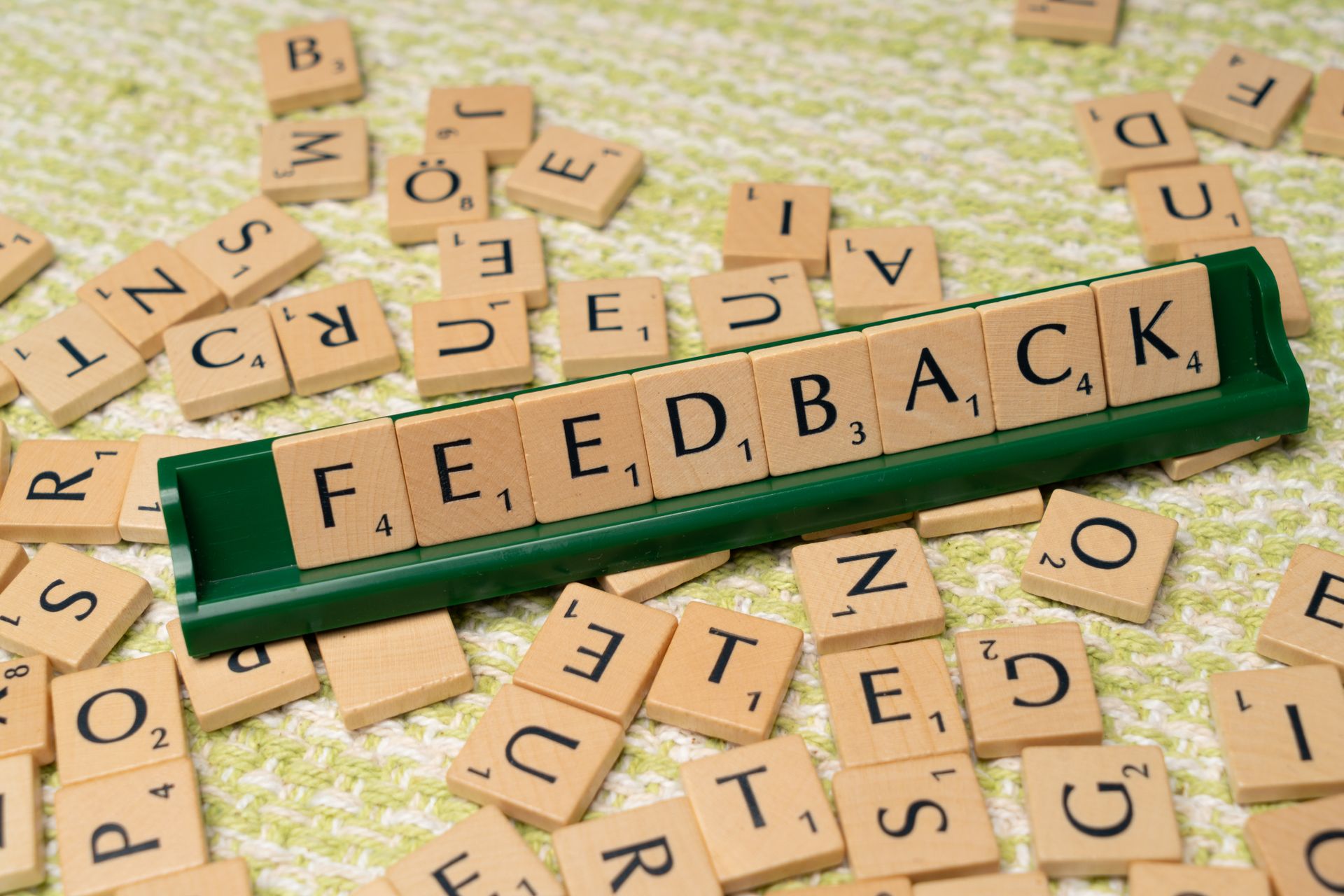 Scrabble tiles spelling a word on a green tile rack