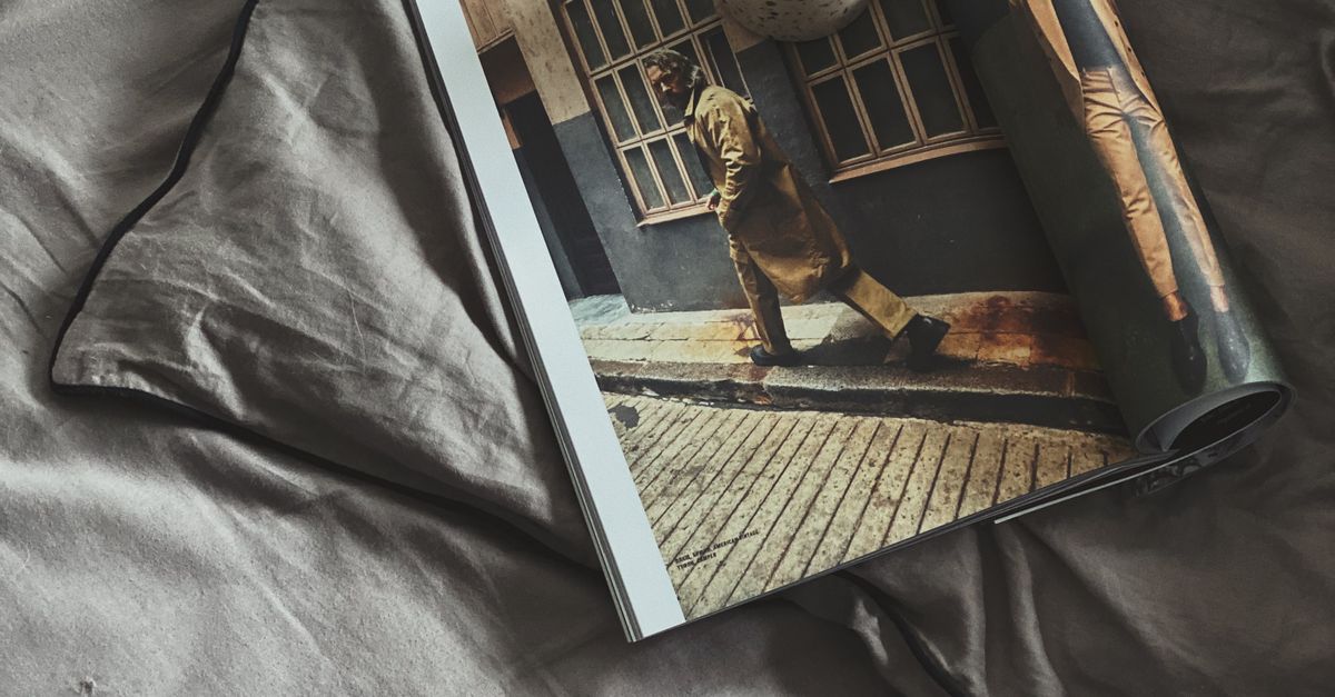 Morning coffee with a magazine on a cozy bed