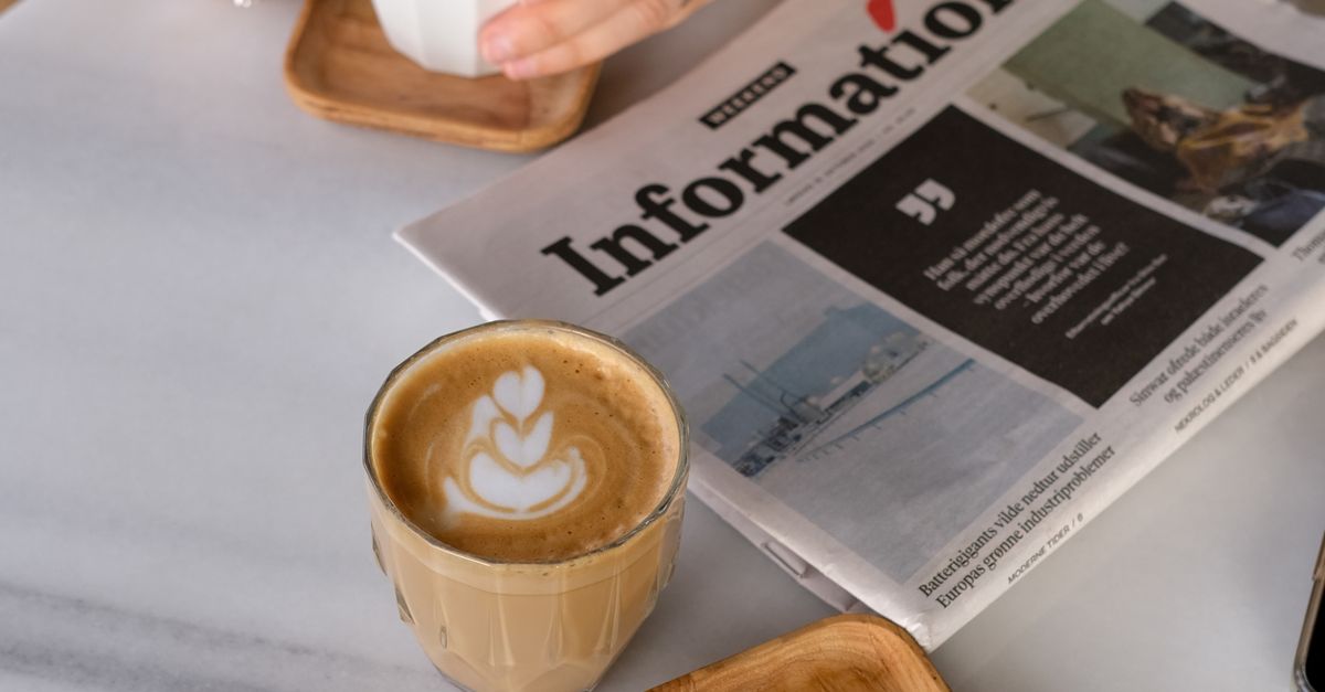Coffee break with a newspaper at a cafe