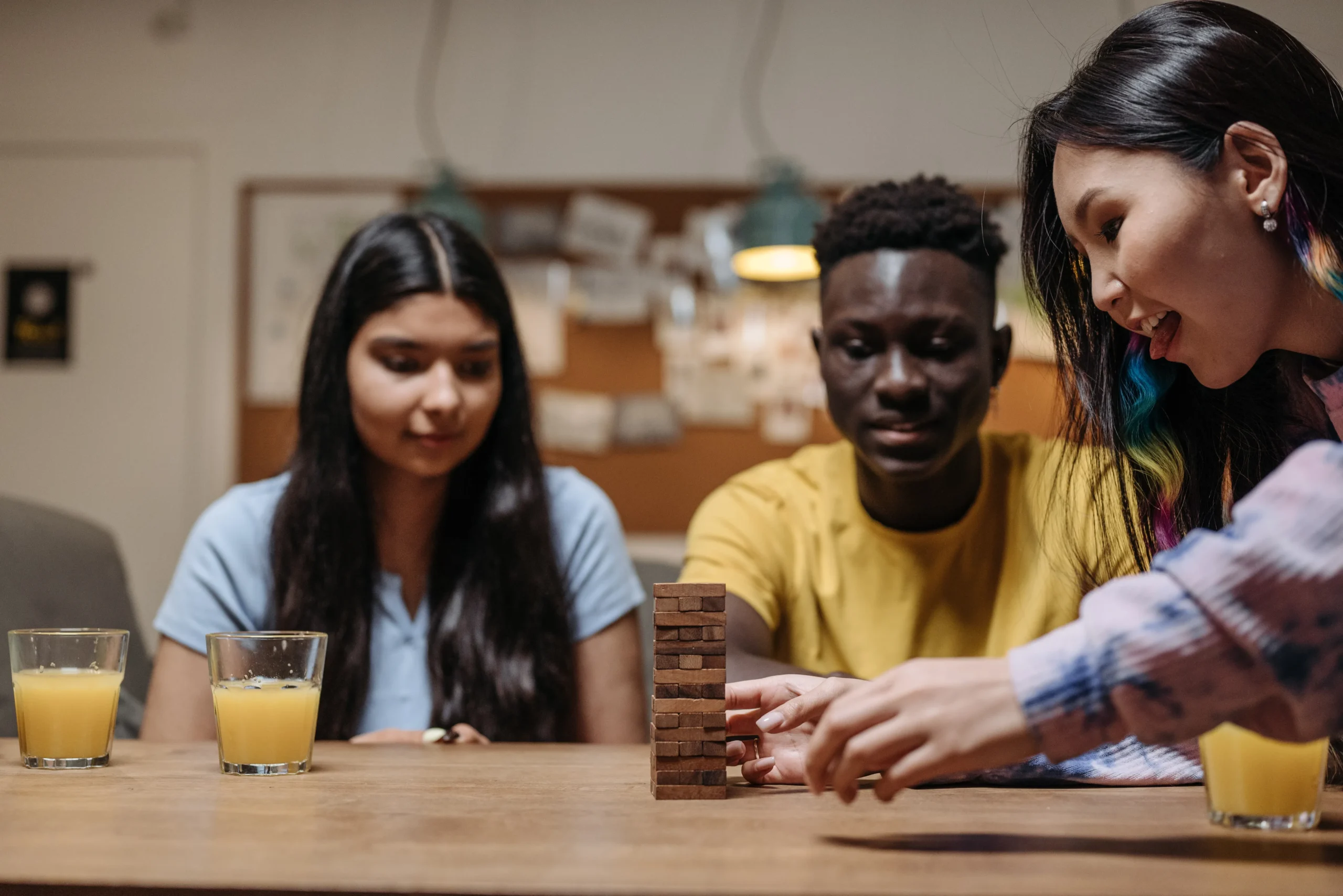 Hands playing a word board game