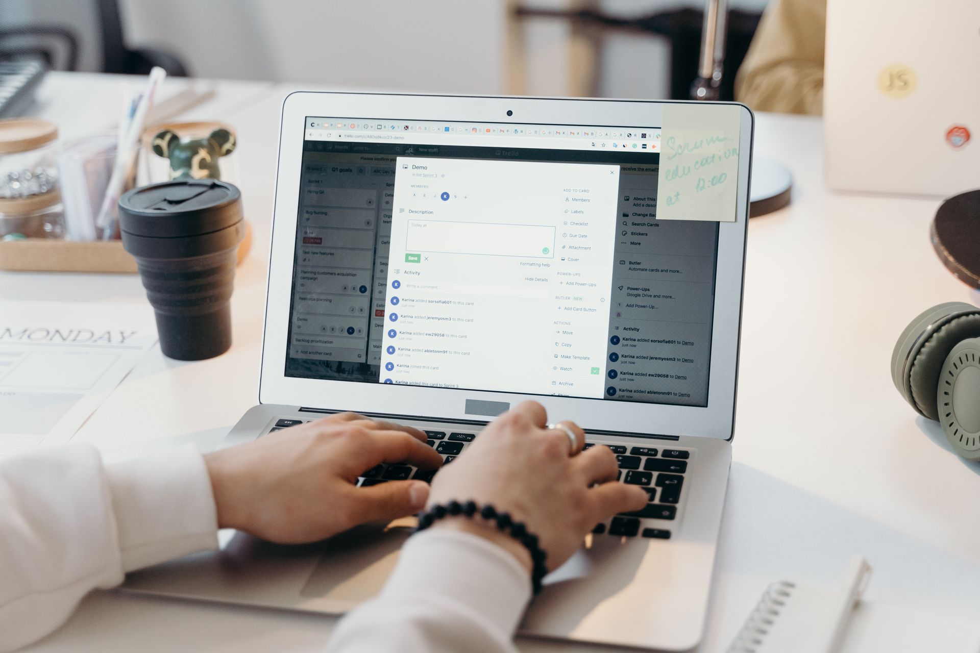 A person typing on a laptop in a bright, modern office setting, showing productivity and technology