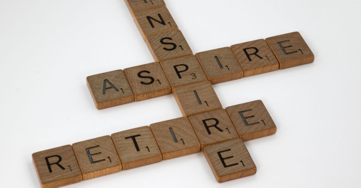 Scrabble tiles spelling inspire, aspire and retire