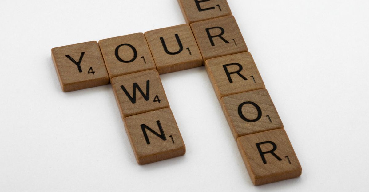 Wooden Scrabble tiles forming a phrase on white