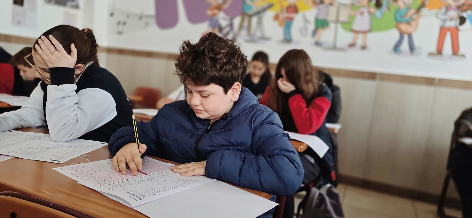Children taking a test with focus in a classroom