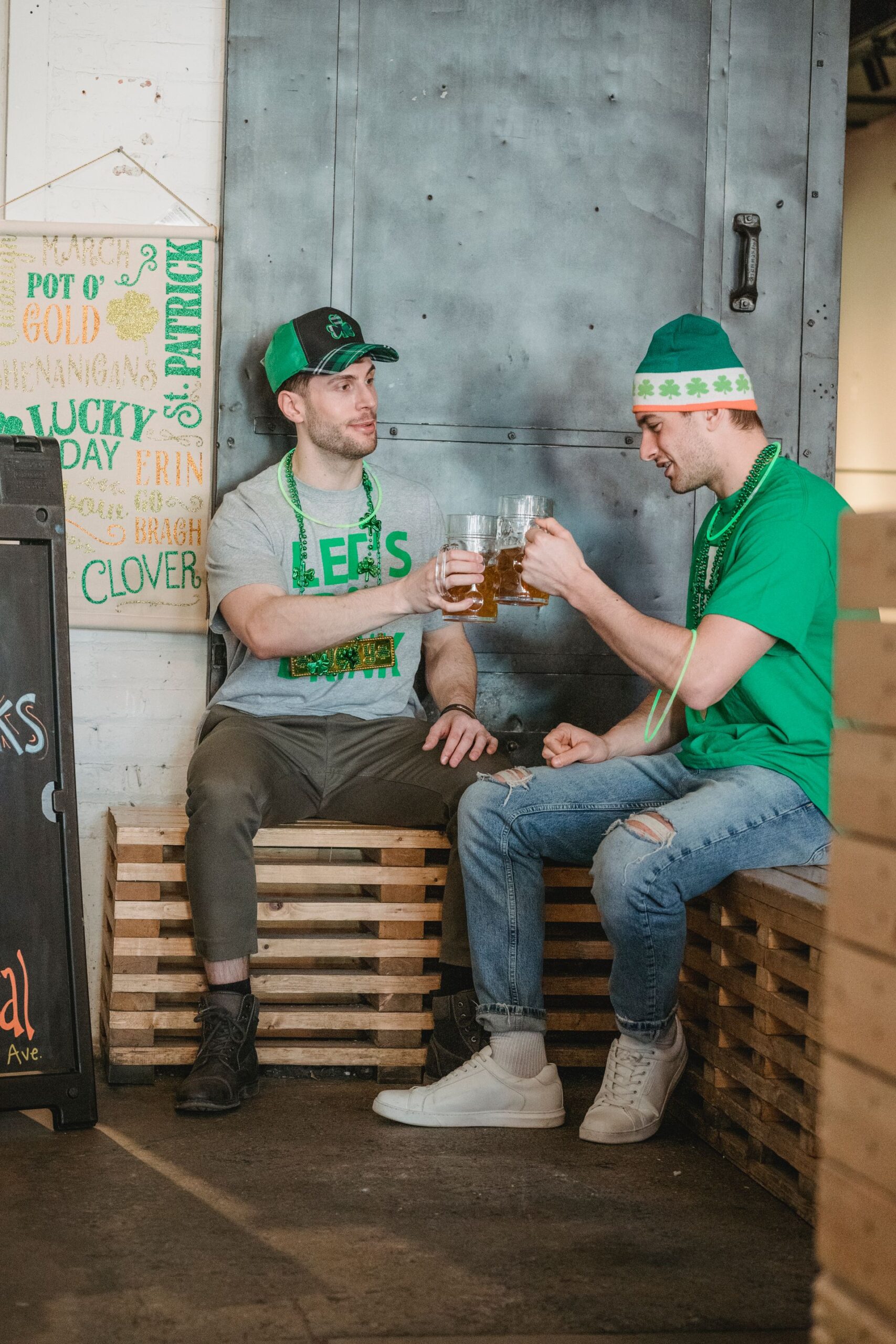 Two friends toasting with beer mugs