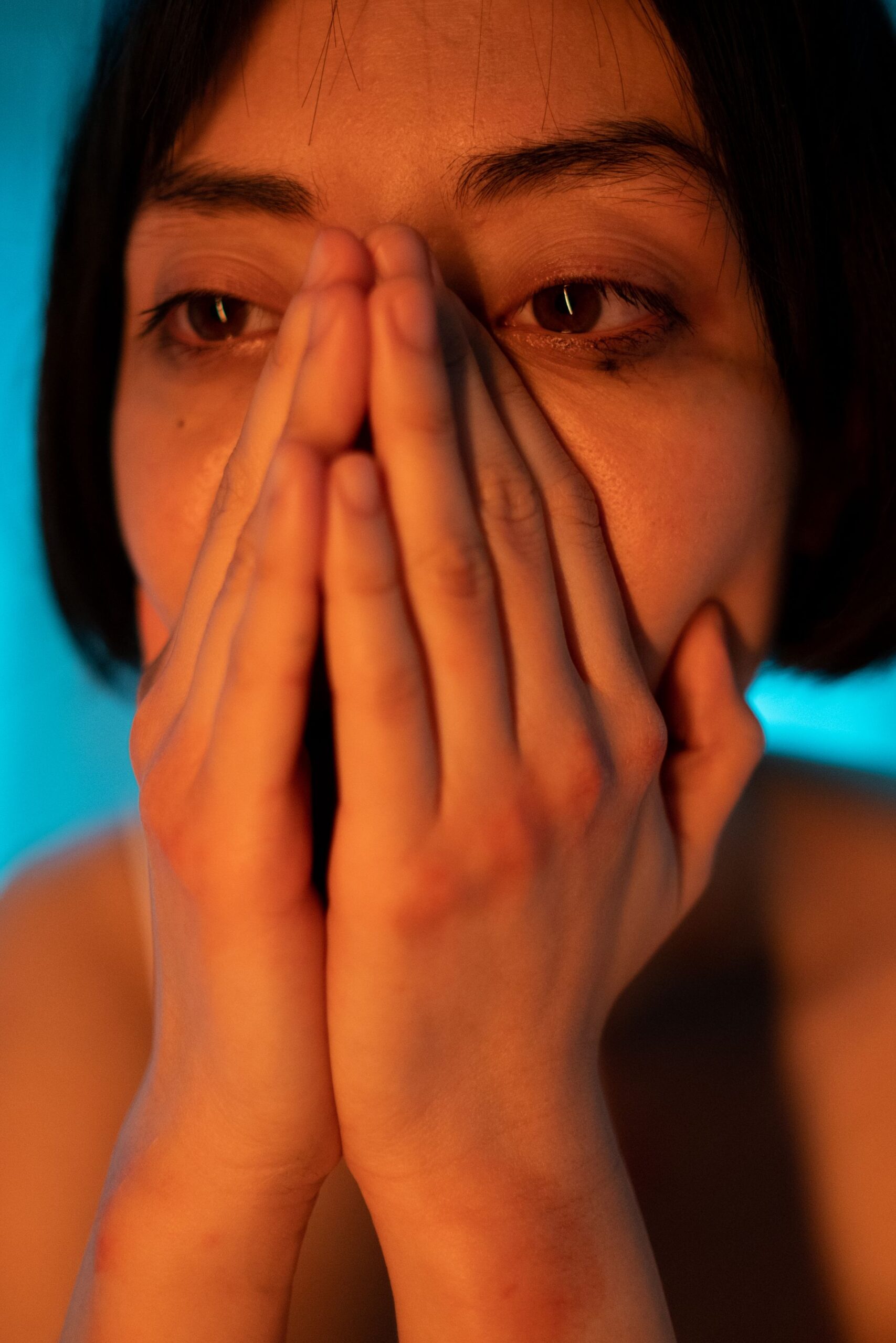 Woman with her face in her hands, frustrated