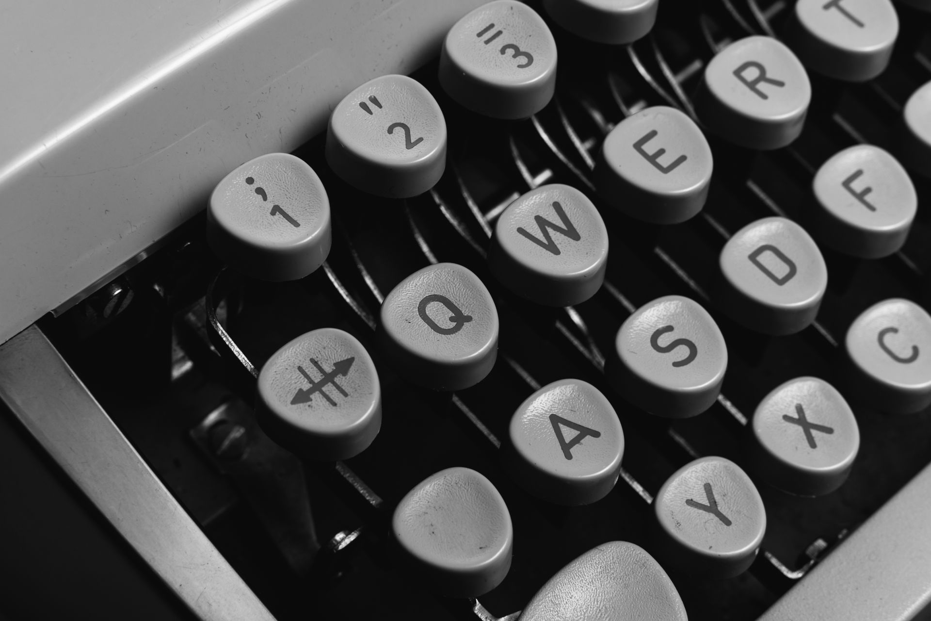 Monochrome image of vintage typewriter keys highlighting classic design and antique technology