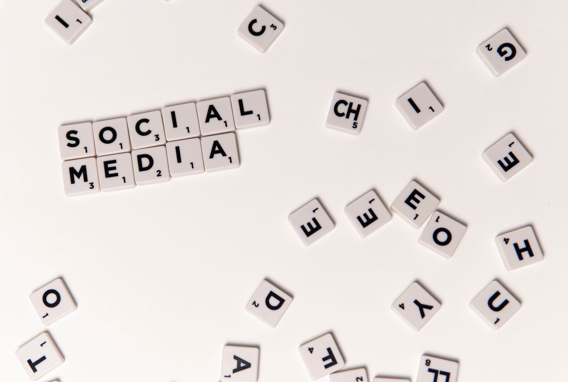 Scrabble tiles spelling 'Social Media' on a white background, symbolizing digital communication.