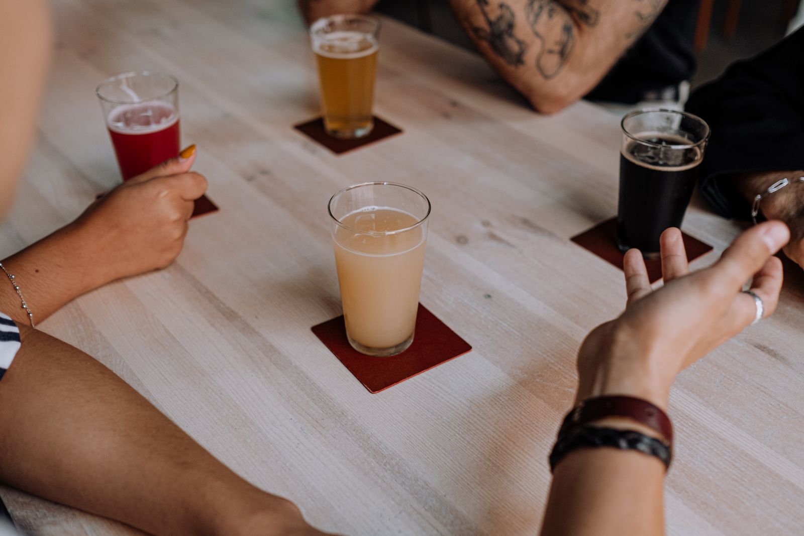 Friends enjoying craft beers at an indoor table
