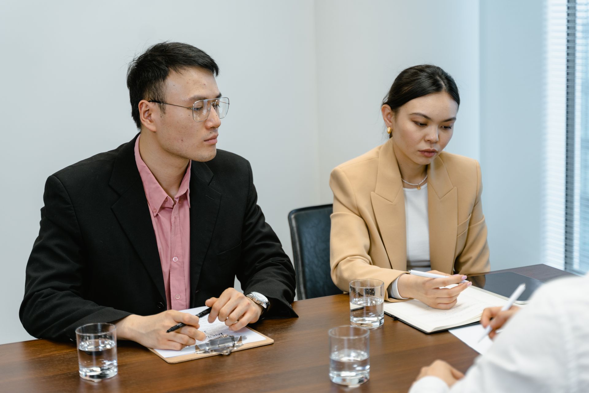 Diverse professionals engaged in a corporate meeting with focus on teamwork and collaboration