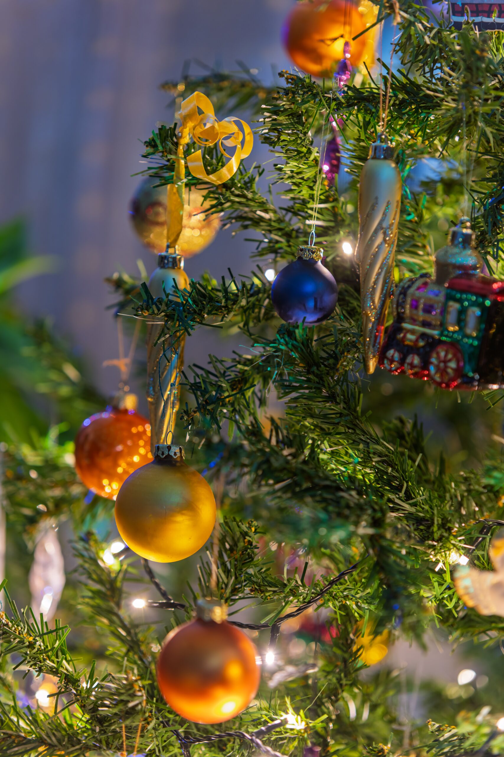 Festive Christmas tree adorned with colorful ornaments and twinkling lights, capturing holiday spirit.