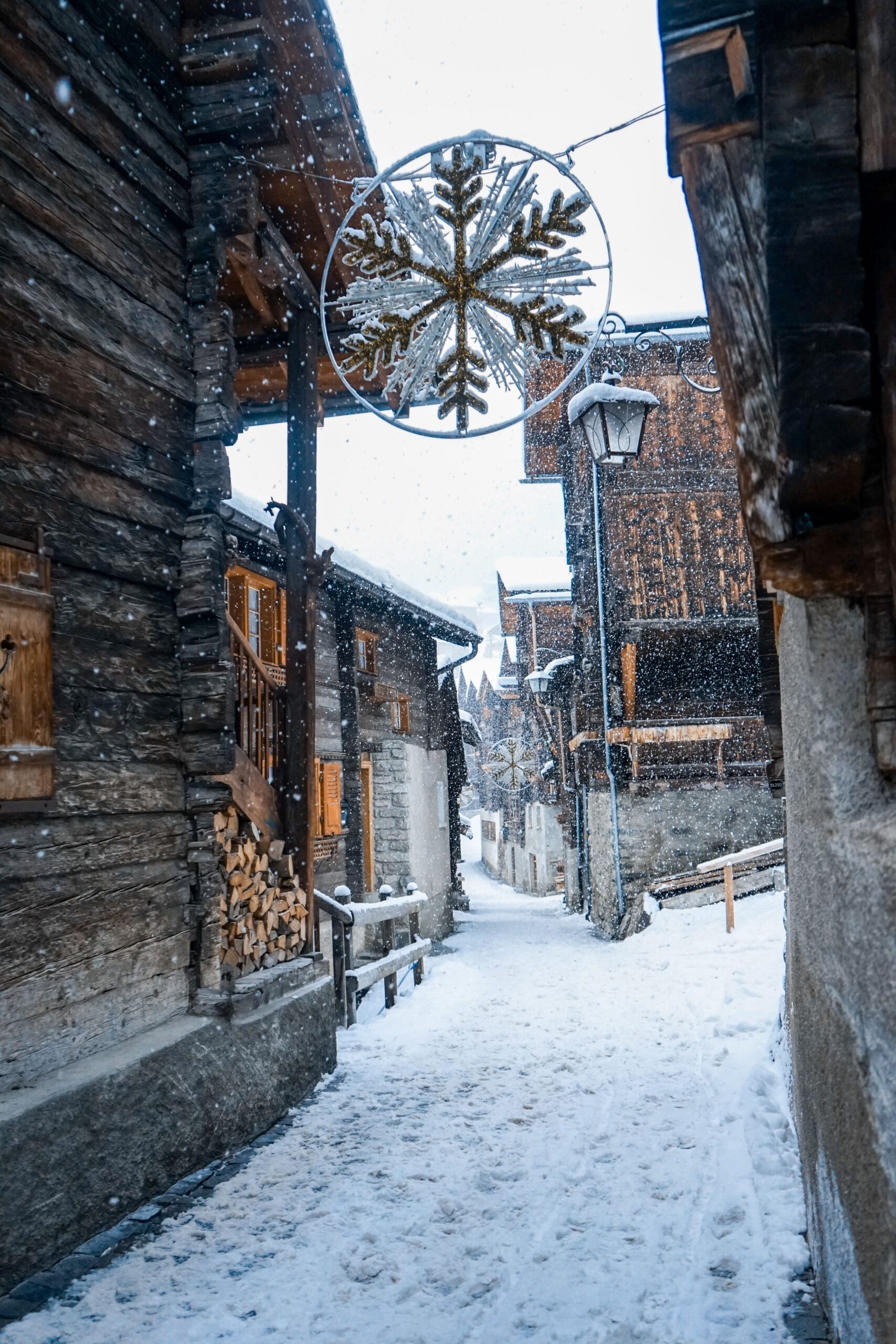Snowy village street with Christmas snowflake decoration