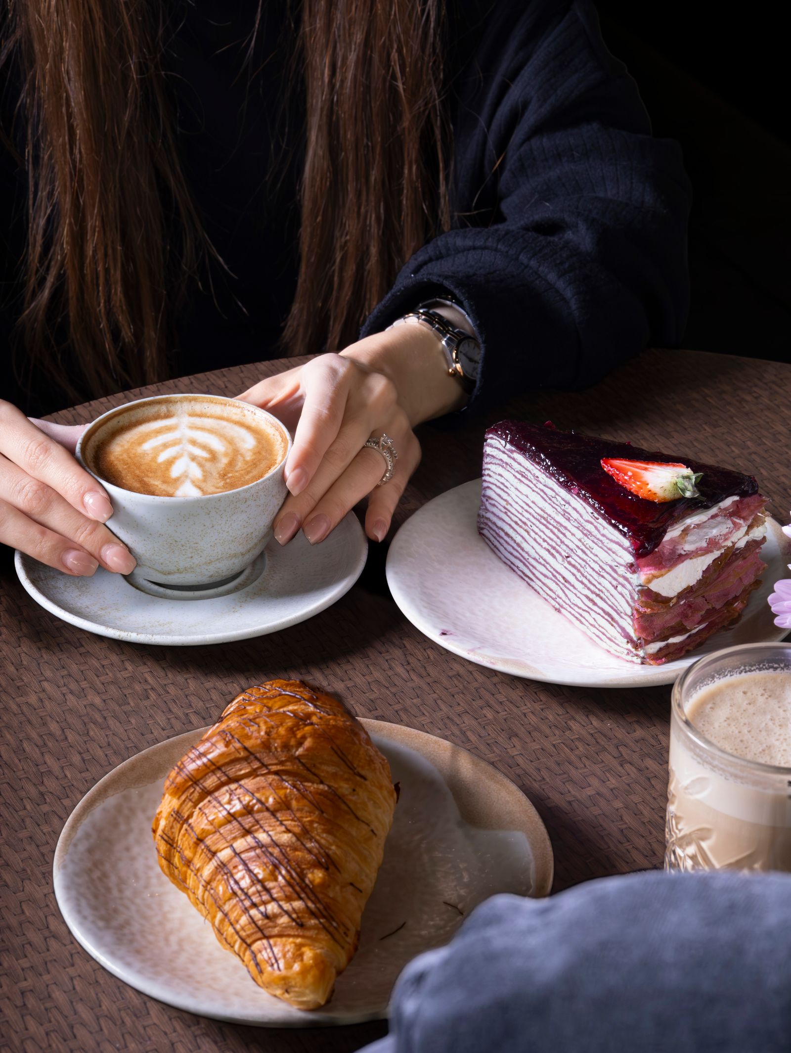 Cozy German-style coffee break with croissant and berry cake in a cafe