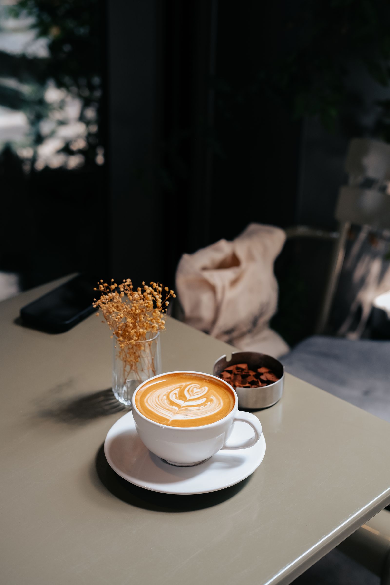 Latte with beautiful froth art served on a table in a cozy cafe