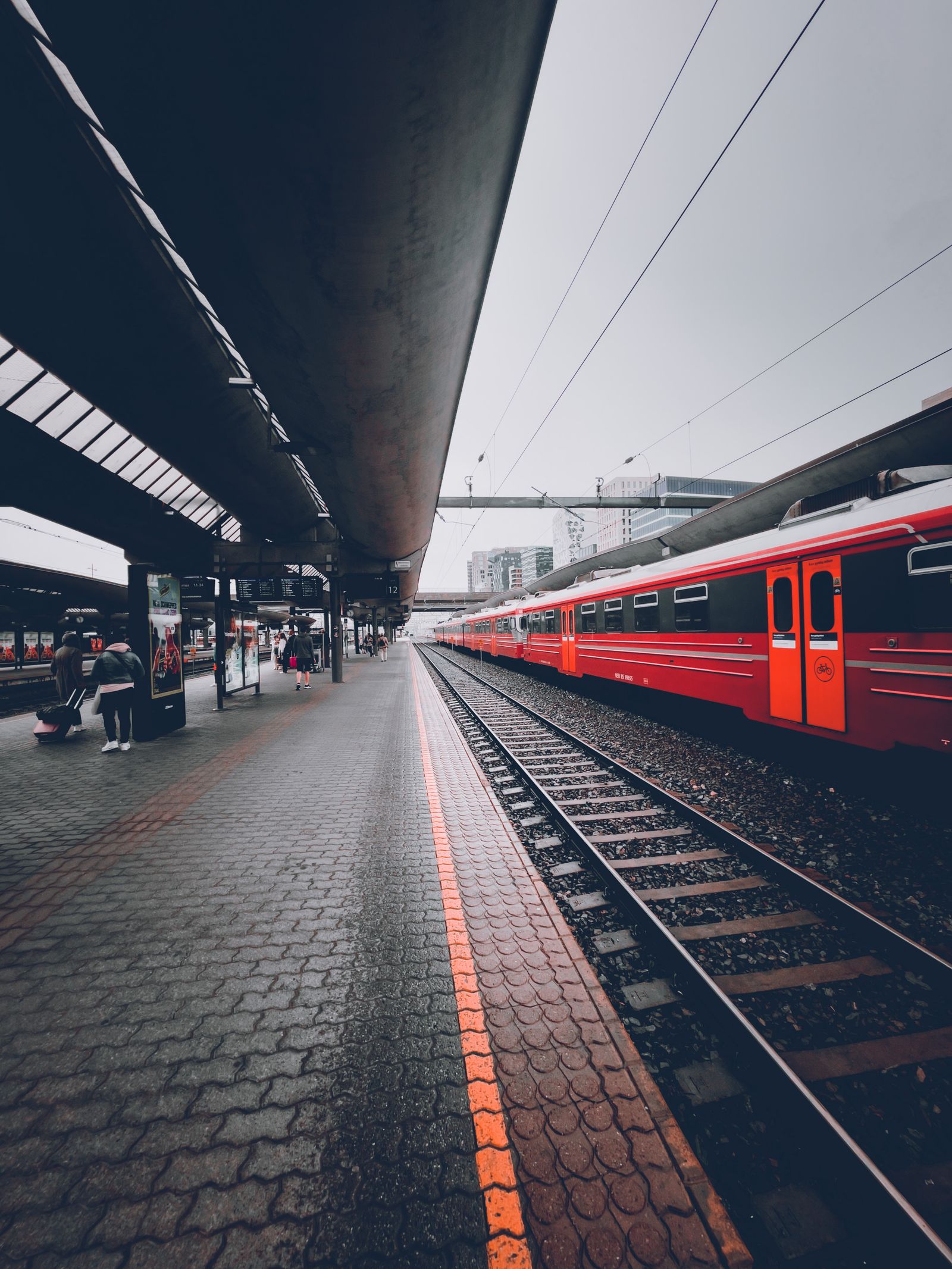 Red train arriving at a railway station