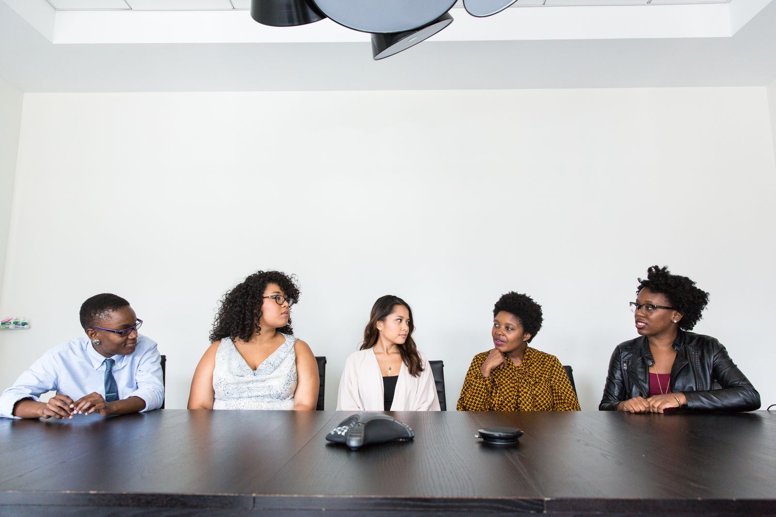 Five colleagues having a conversation in an office