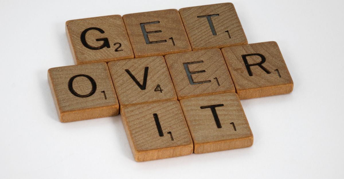 Brown wooden Scrabble blocks on a white surface