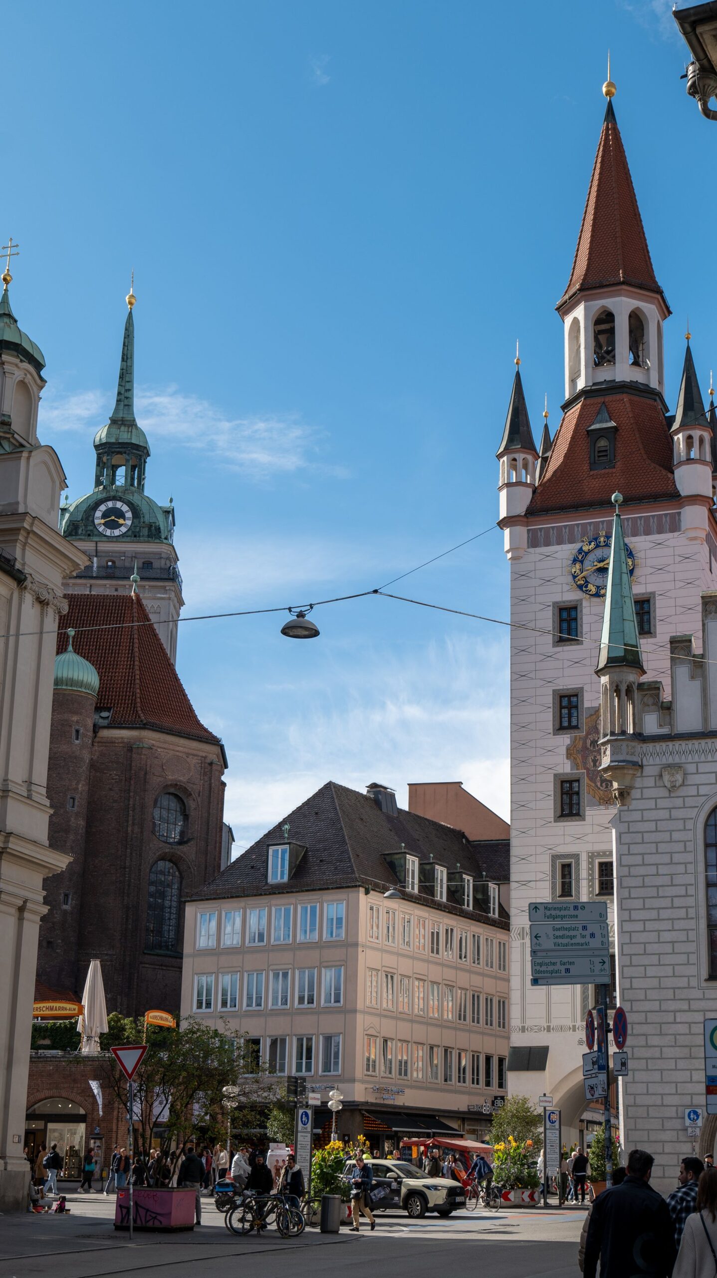 Munich old town with church towers and pedestrian direction signs