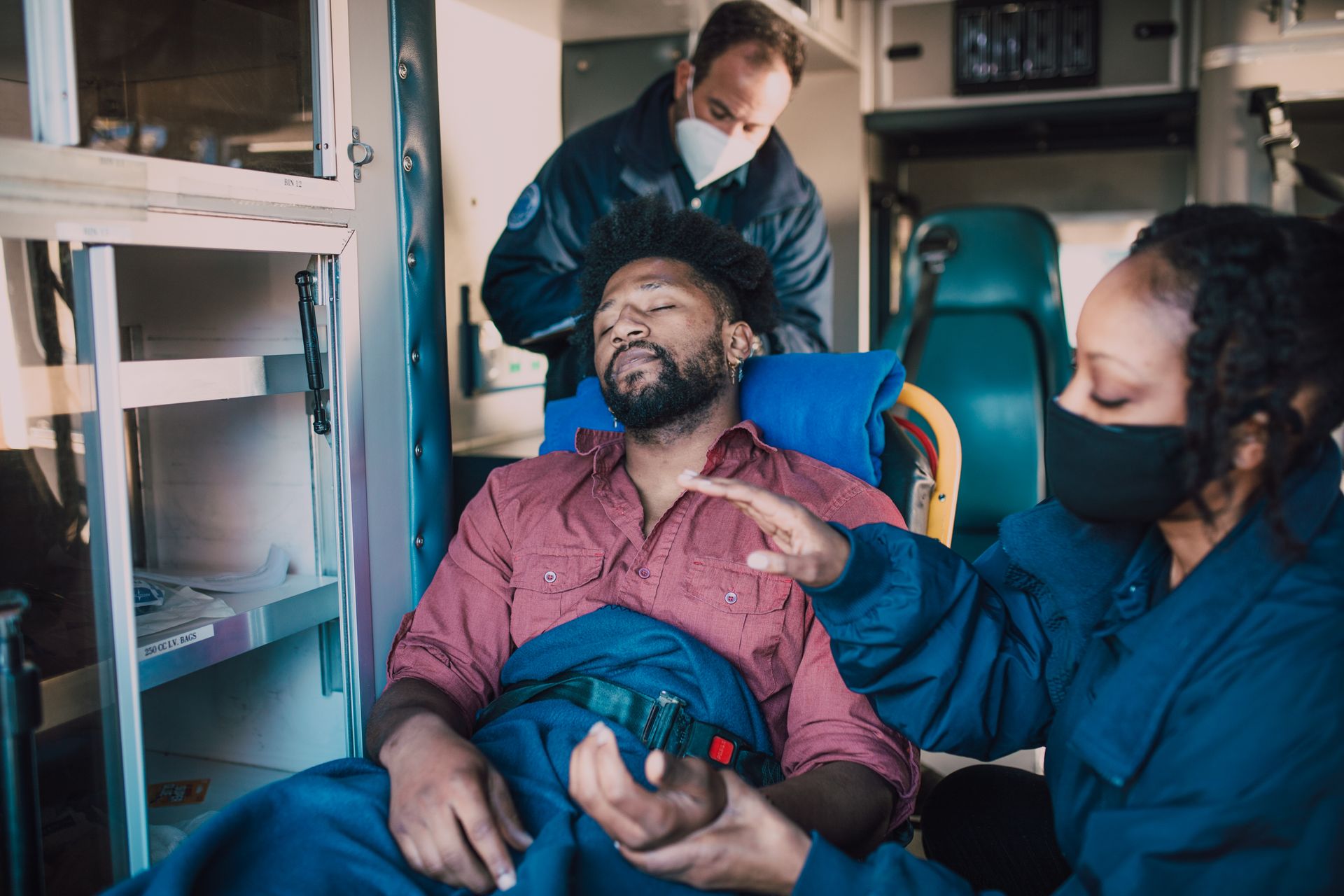 Paramedics providing urgent care inside an ambulance
