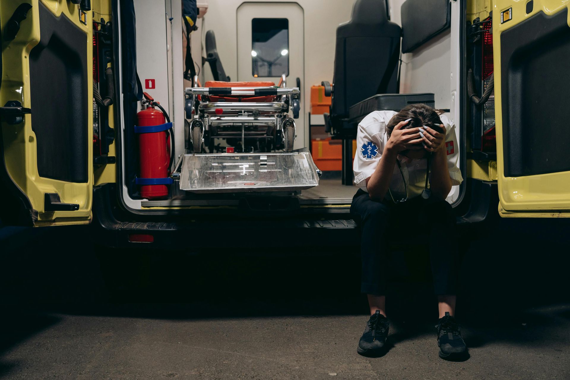 Paramedic resting by an ambulance after an emergency call