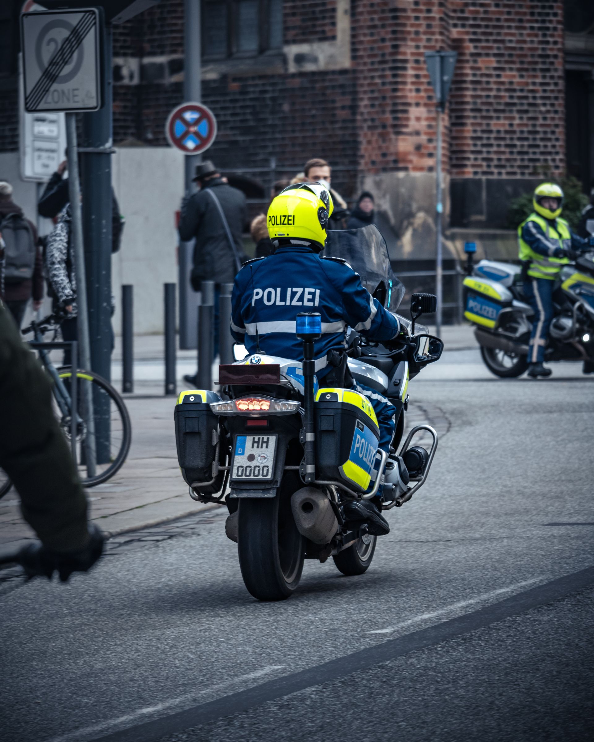 German police officers on motorcycles patrolling a city street
