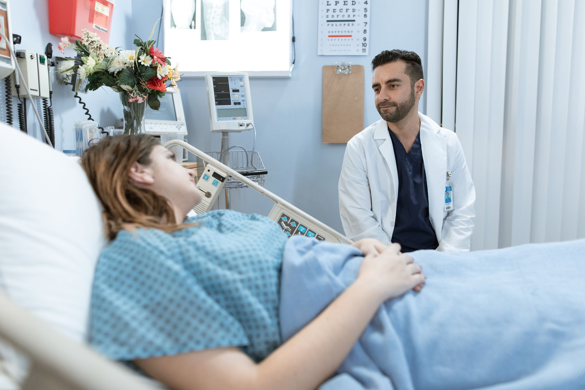 Doctor comforting a patient in a hospital room