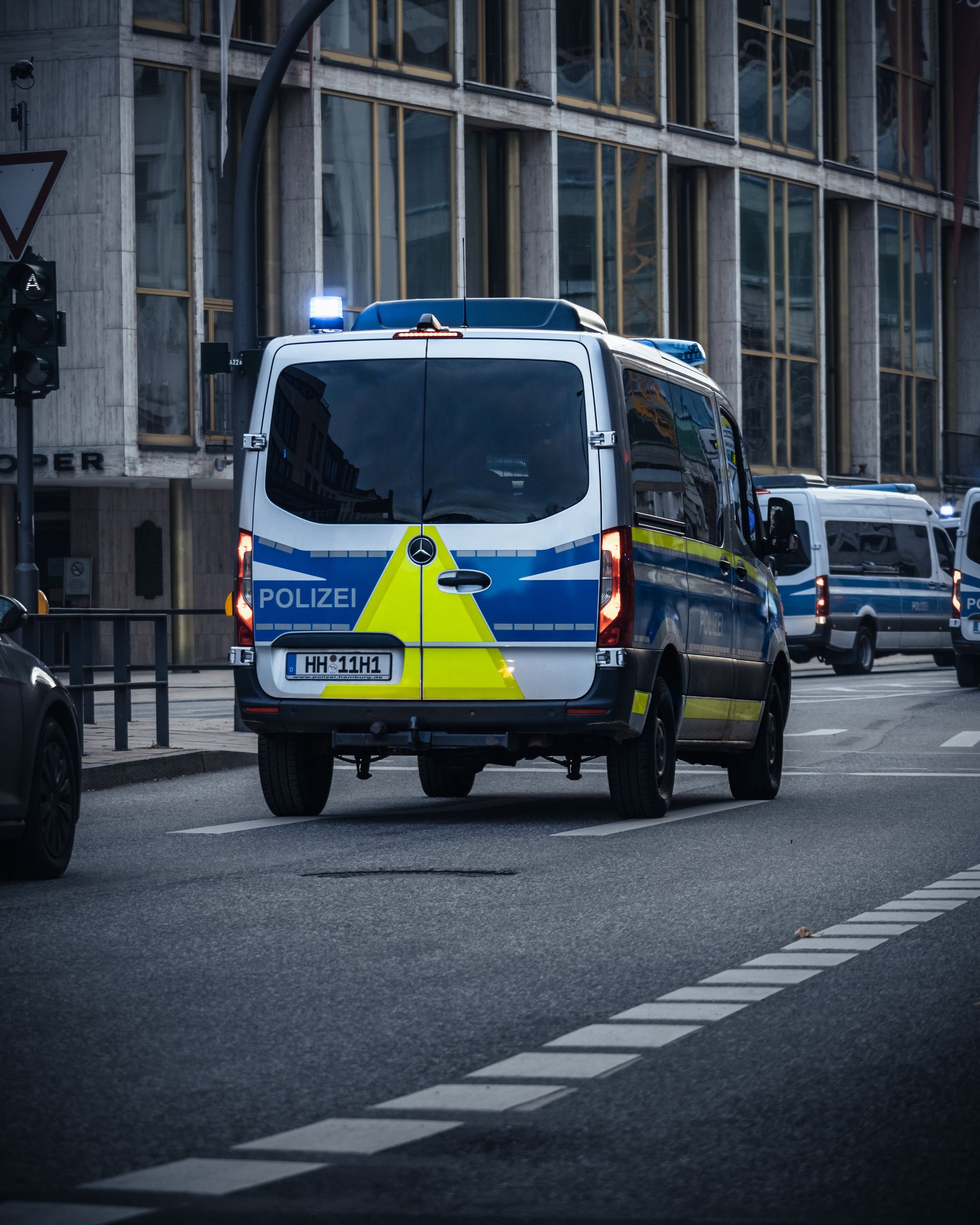 Police vans parked on a city street ready for emergency response
