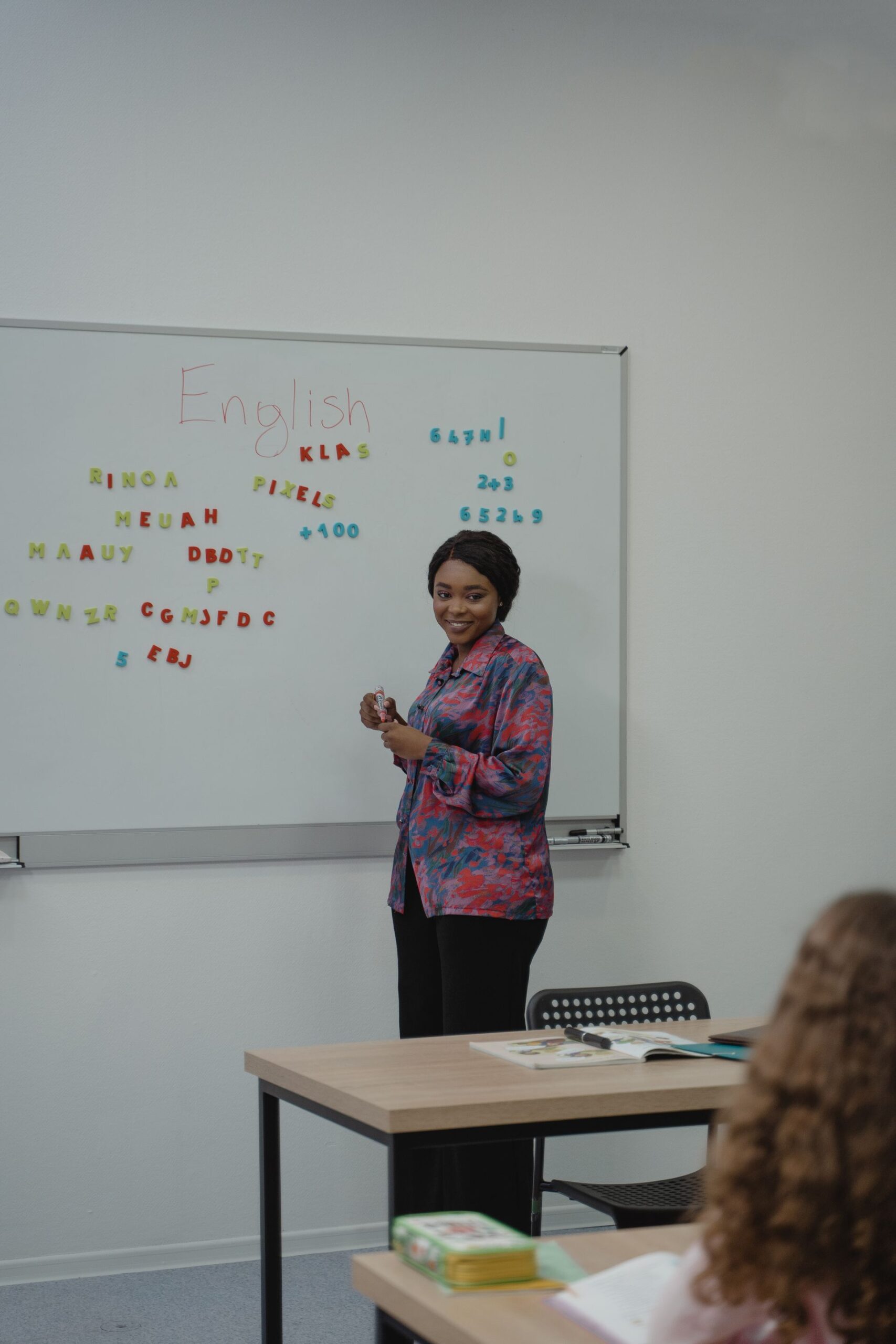 Female teacher explaining an English lesson in a classroom