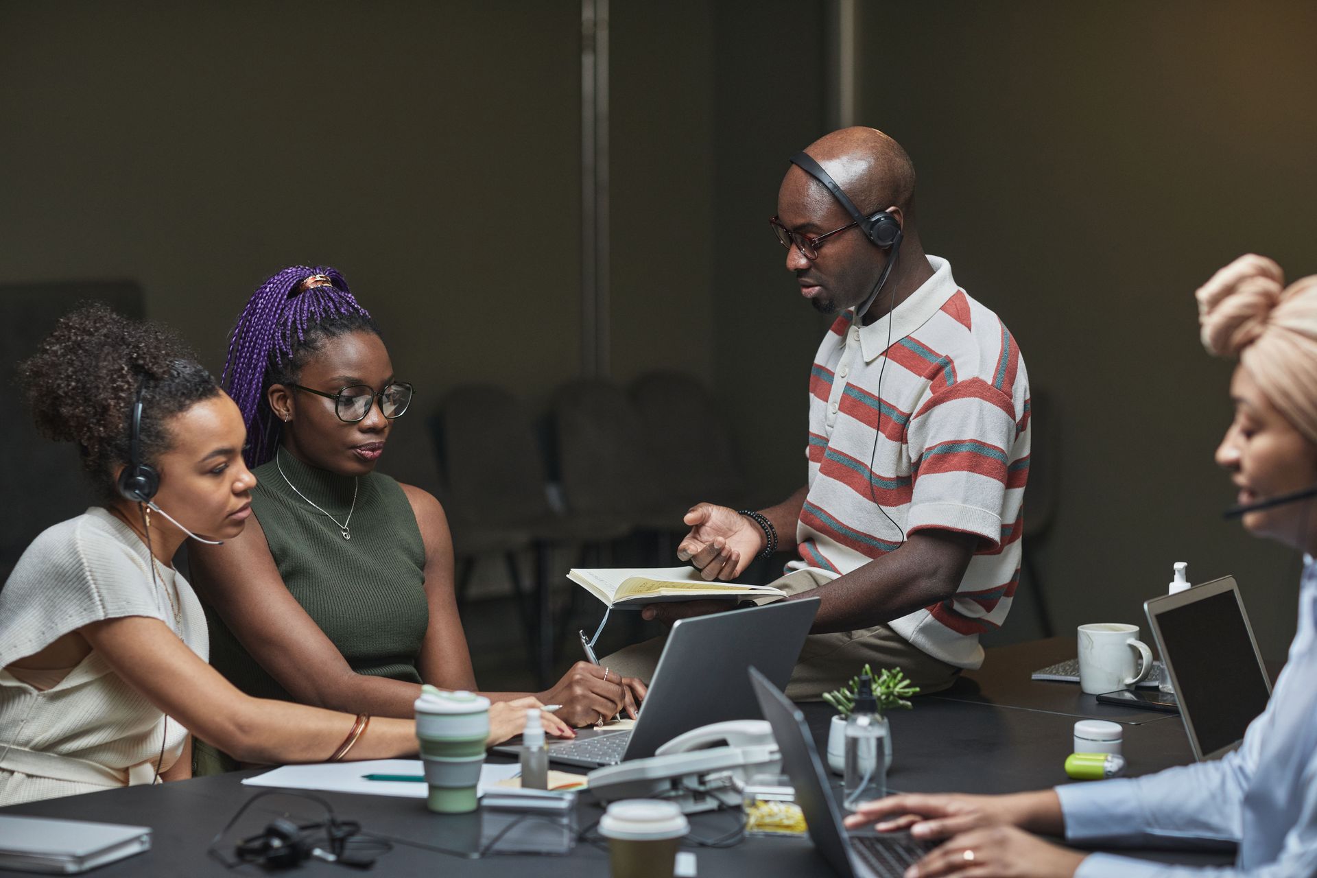 Colleagues discussing plans at work in a modern office