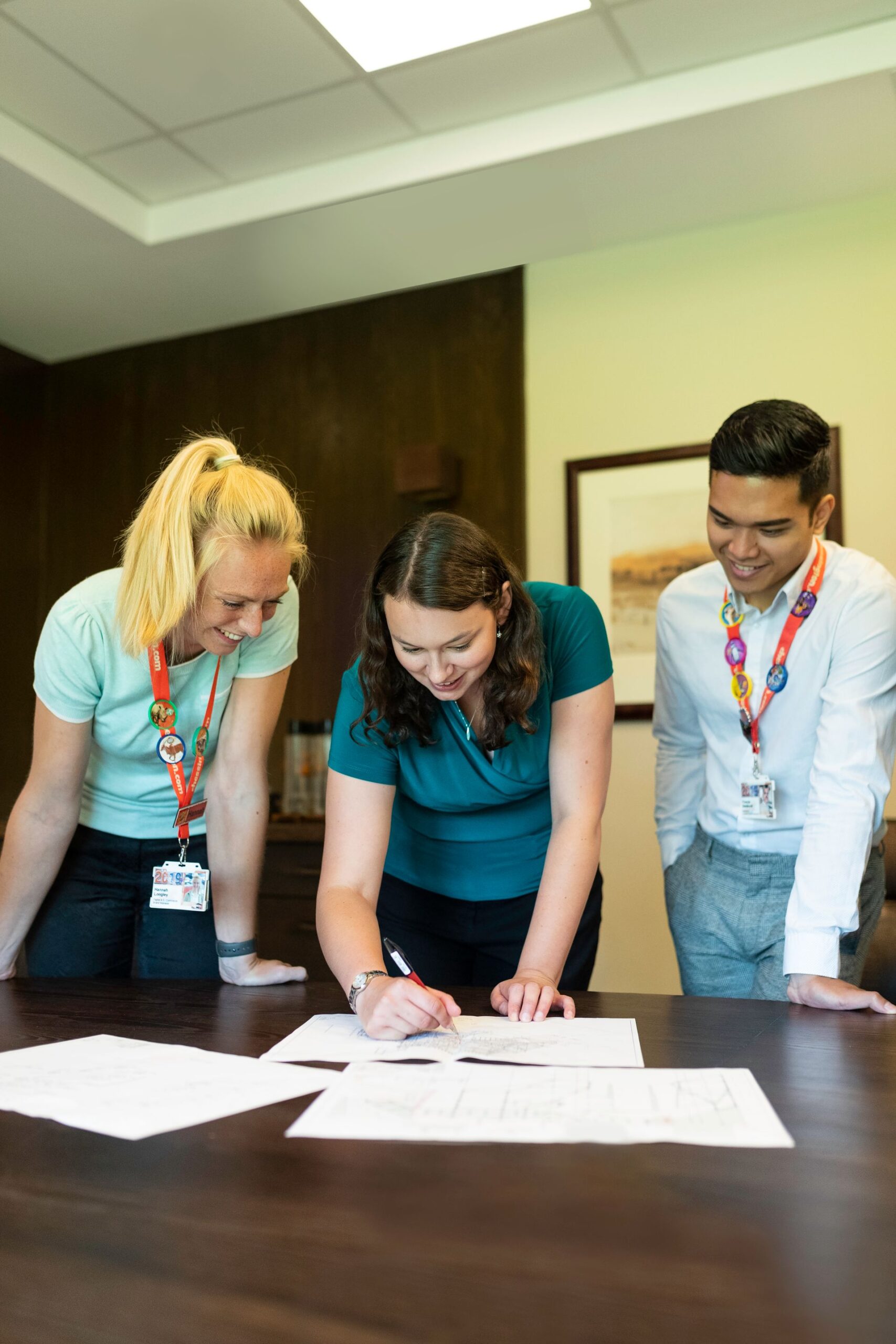Three colleagues collaborating around an office table