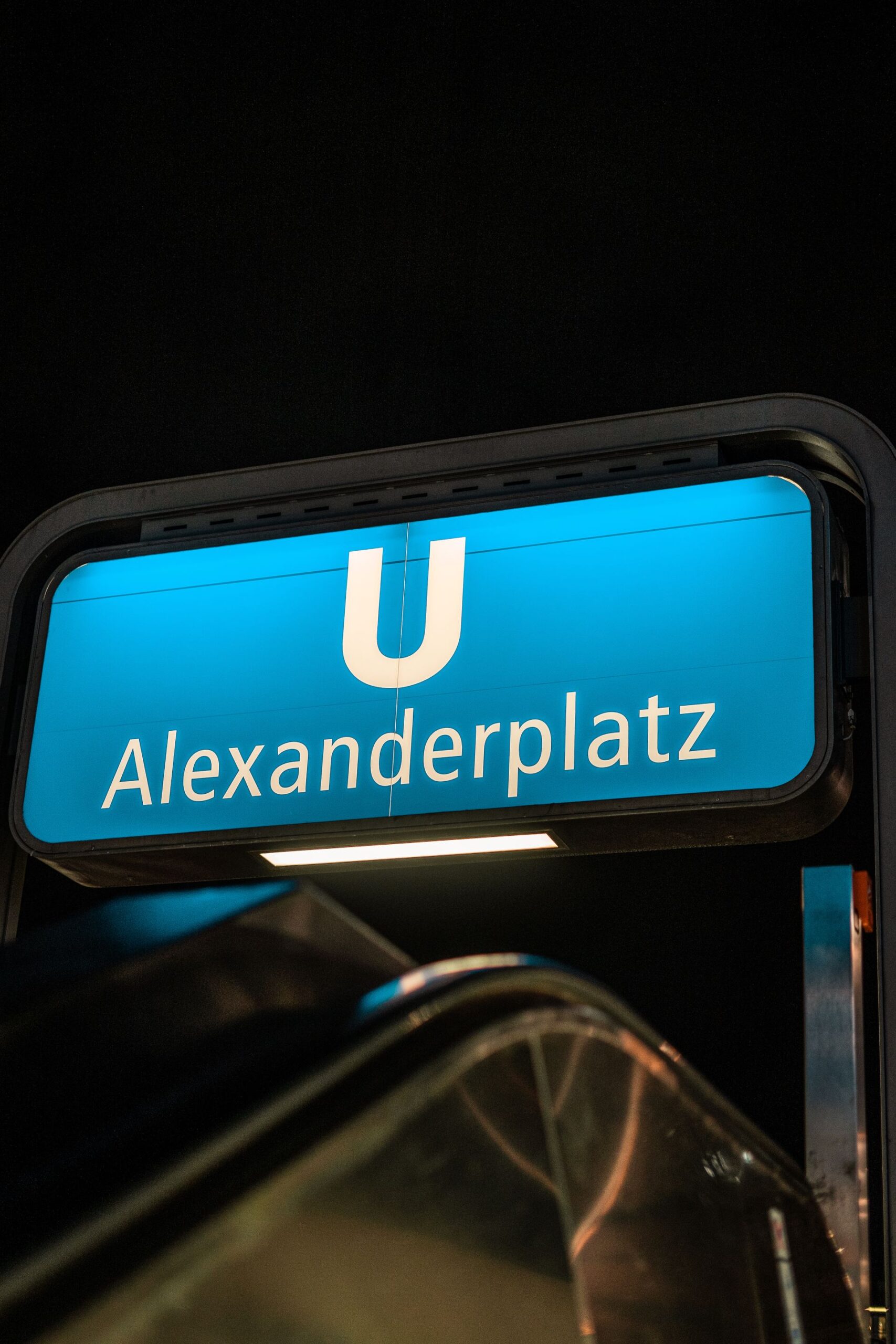 Alexanderplatz subway sign illuminated at night in Berlin