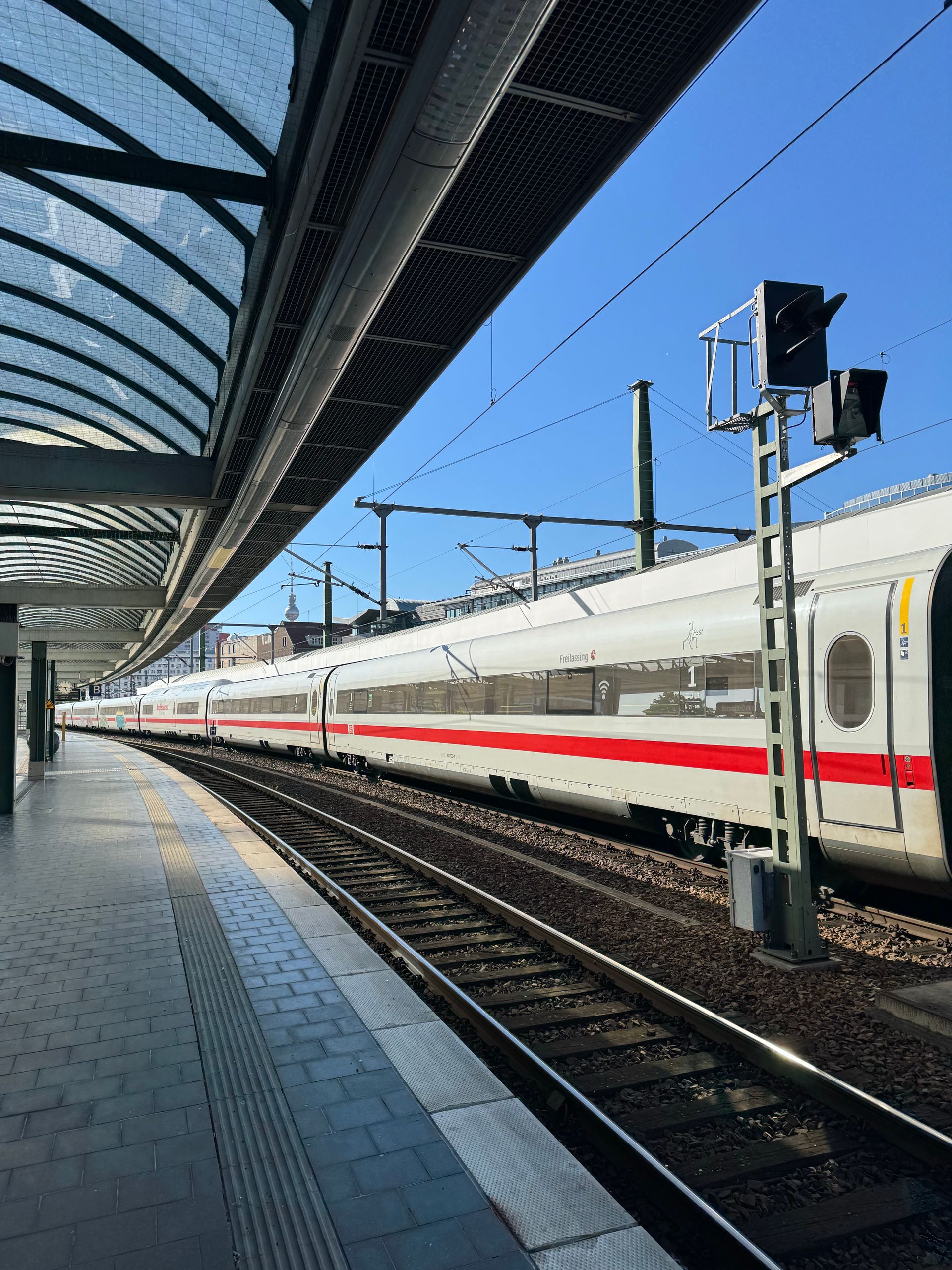 High-speed train at a Berlin station platform on a sunny day