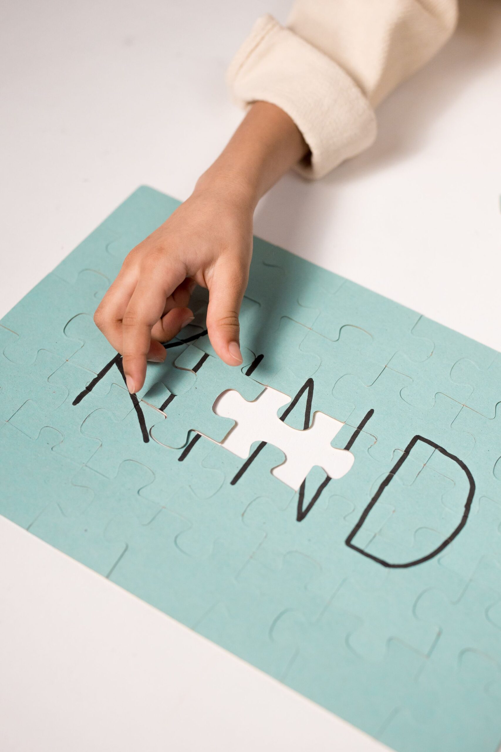 A hand placing the final piece in a jigsaw puzzle