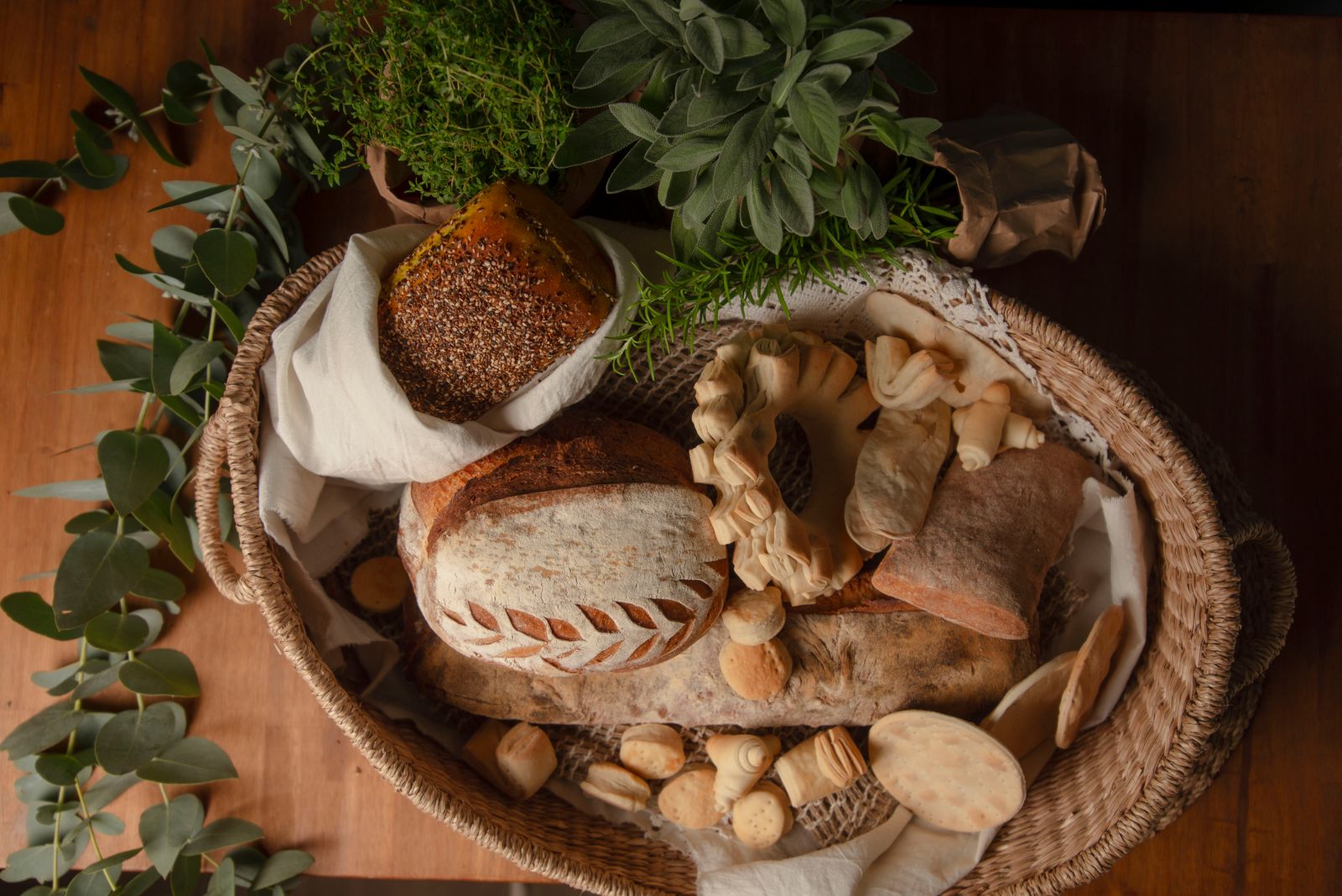 Rustic bread basket with herbs and assorted breads