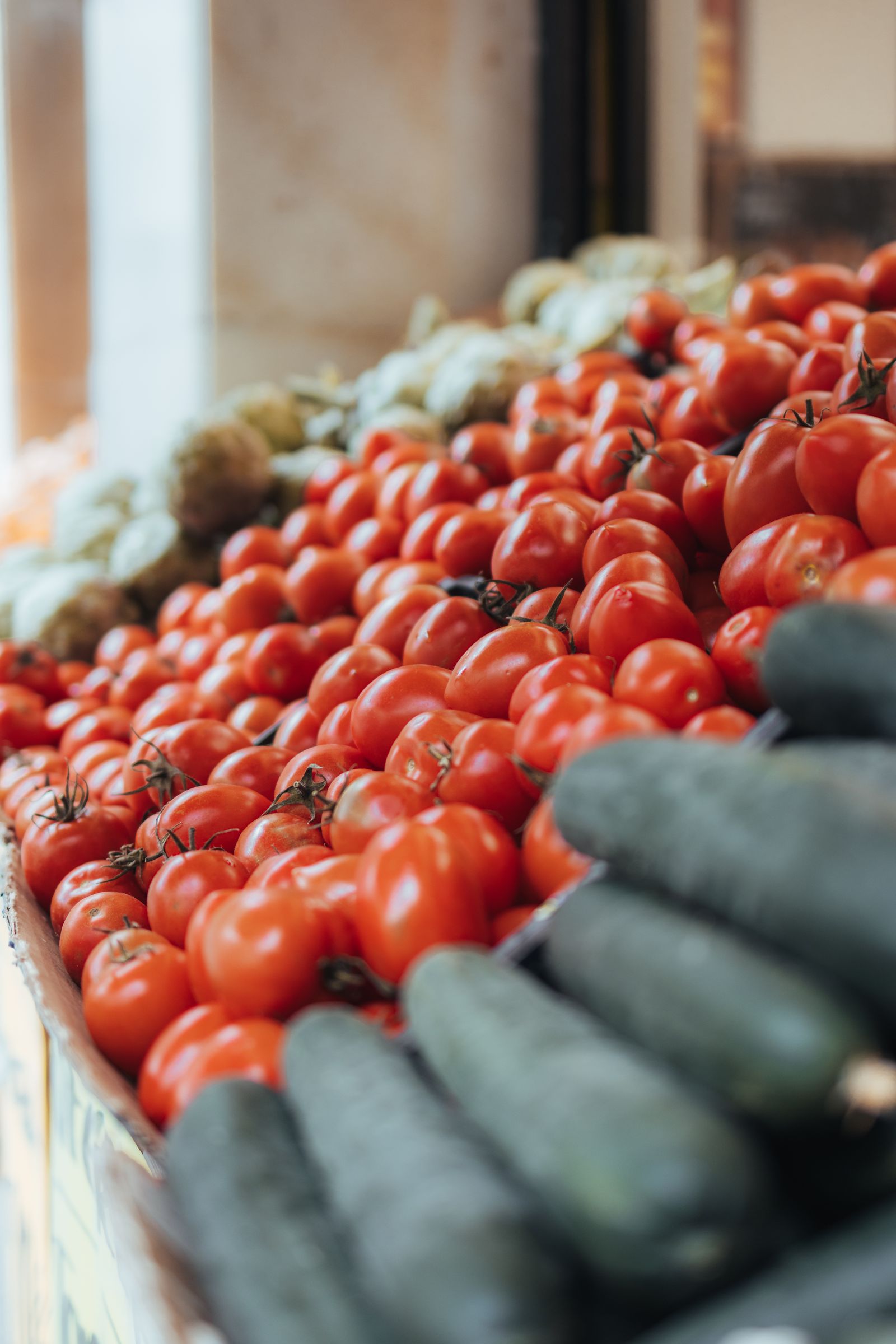 Fresh tomatoes and cucumbers at a market